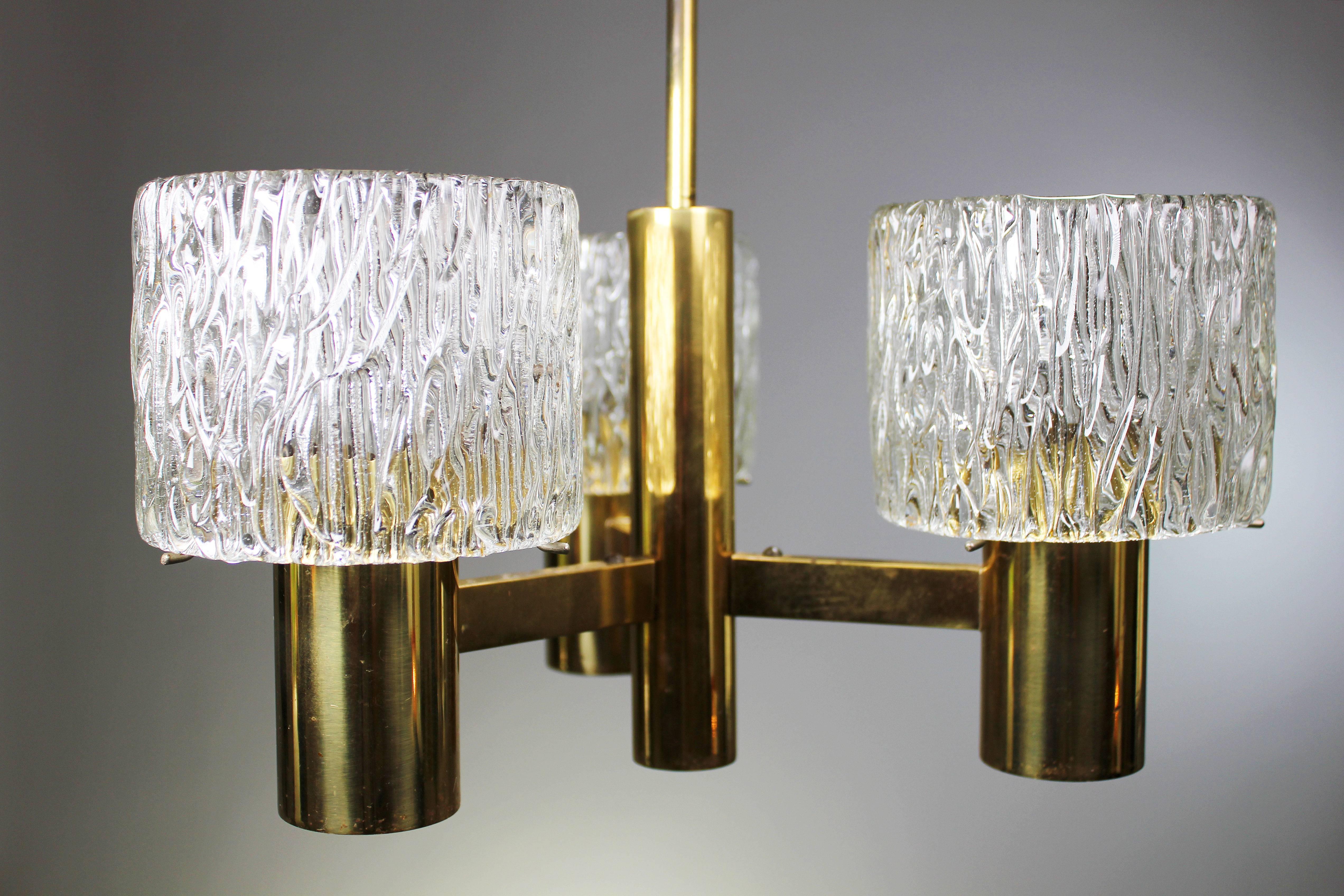 Classic Swedish Mid Century Modern chandelier with three tubular textured glass on brass mount. By acclaimed art glass designer Carl Fagerlund for Swedish Orrefors in the late 1950s. Original brass stem and canopy. Rewiring upon request - local