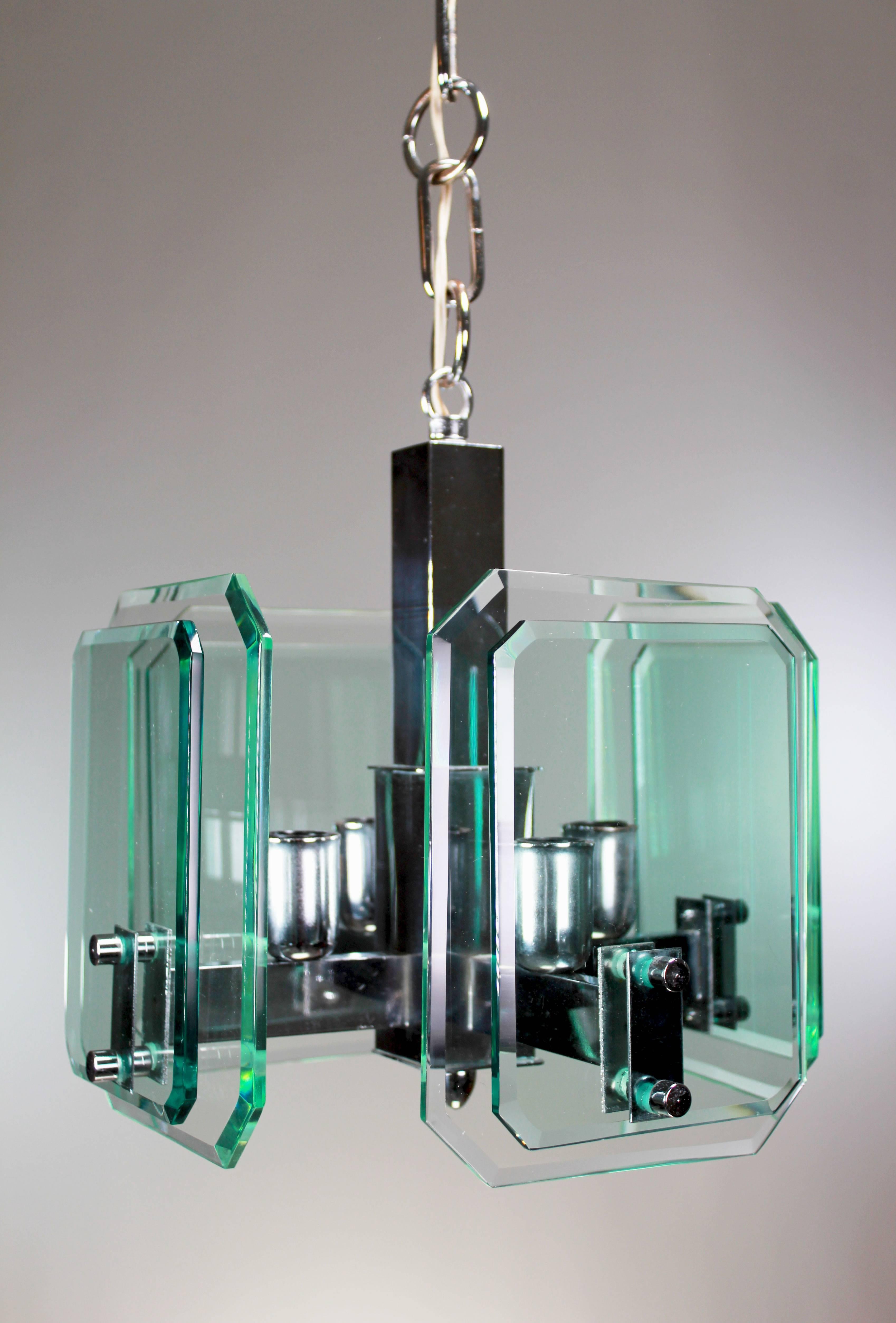 Beautiful architectural Italian Mid Century Modern pendant with chrome arms holding eight plates of cut tempered glass with a green tint in two different sizes. In the style of Fontana Arte, attributed to Veca. Manufactured in Italy in the early