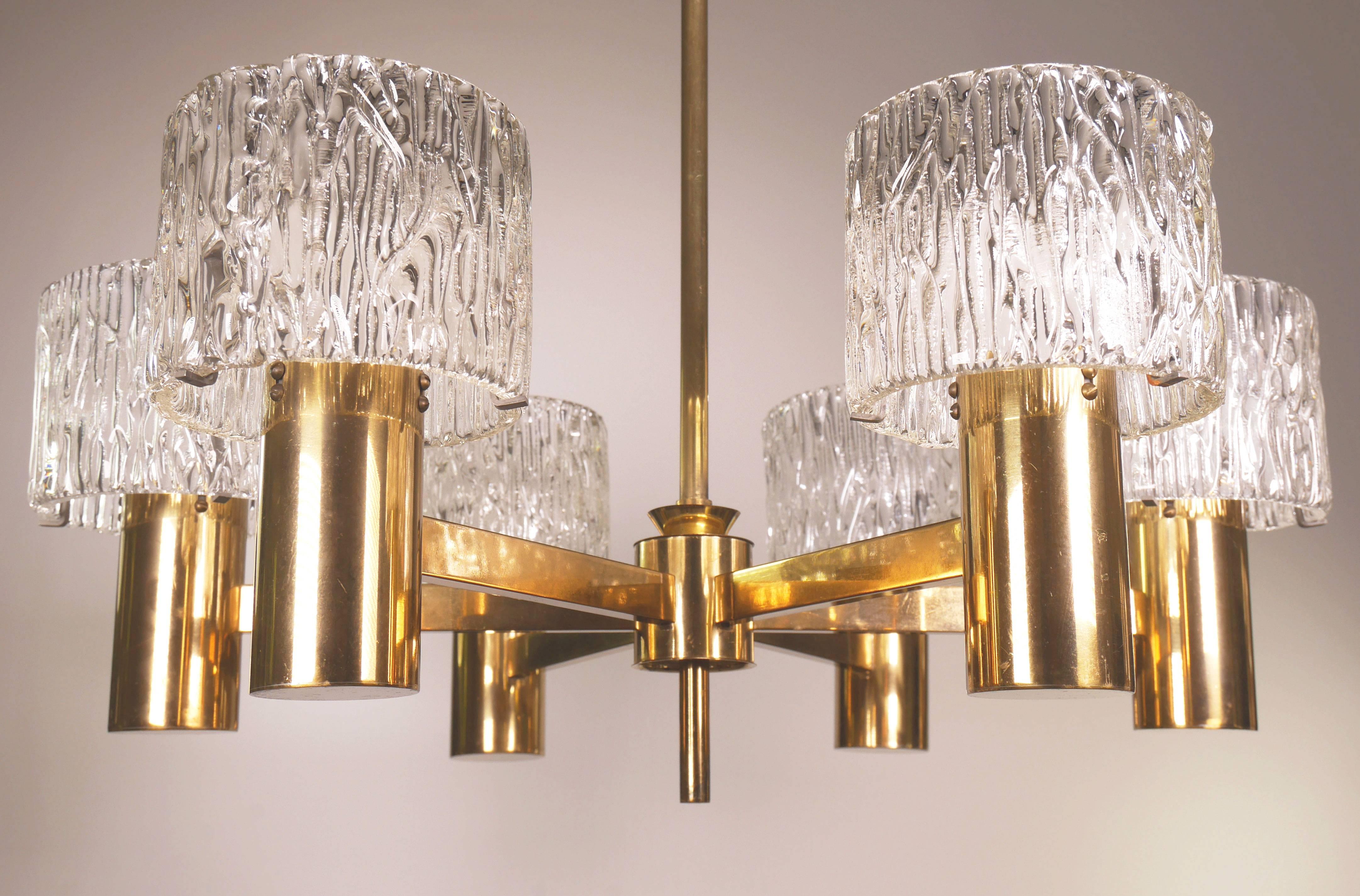 Six-arm Mid-Century Swedish Modern chandelier composed of textured tubular glass on brass mount, brass stem and brass canopy. Designed by Carl Fagerlund for Swedish Orrefors.