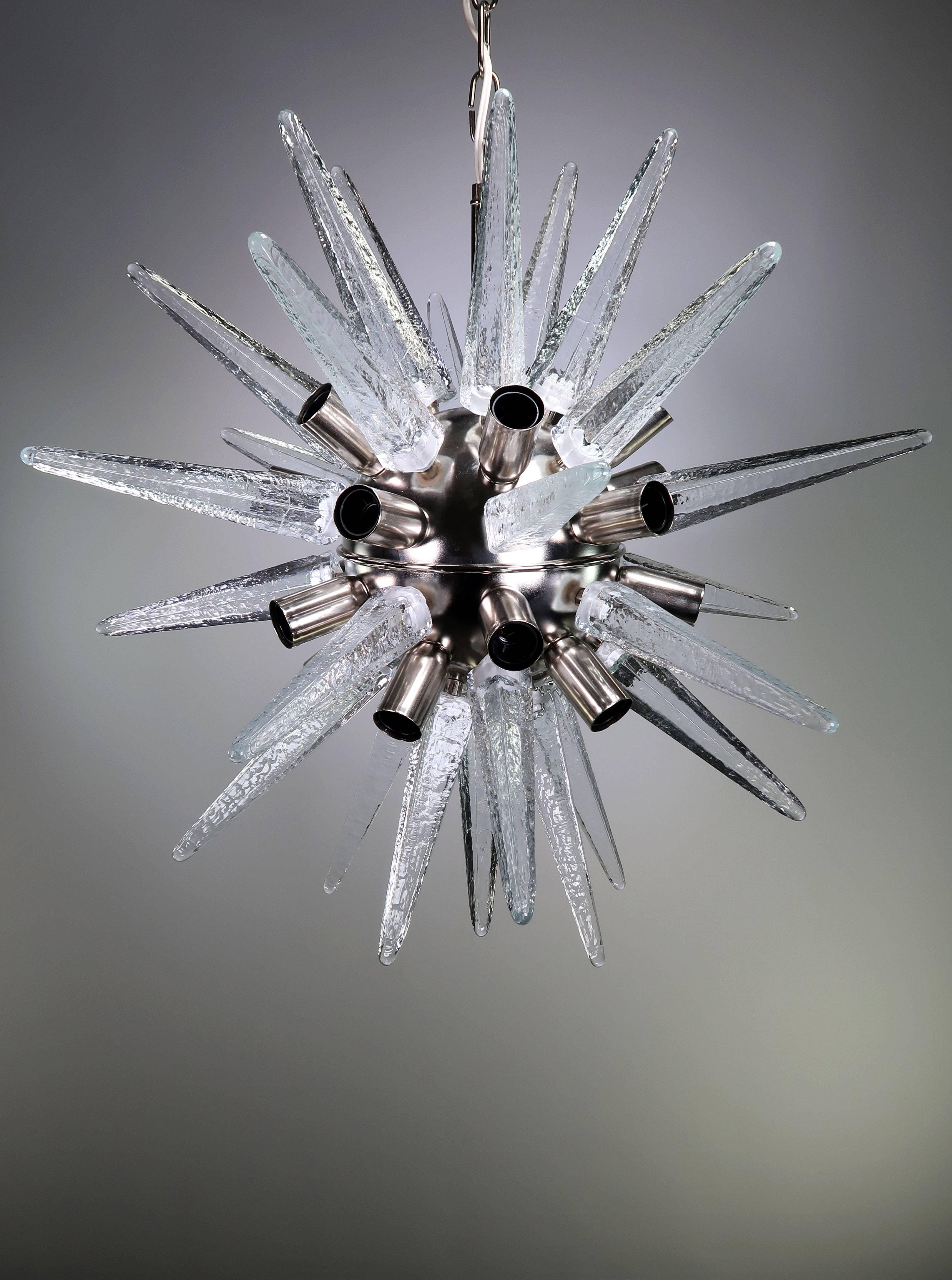 Spectacularly eye-catching Murano sputnik chandelier with 31 clear, textured, handblown glass spike elements. Twenty-light bulbs and 31 glass elements mounted on a nickel base with original chain and canopy. Manufactured on the Italian Venetian