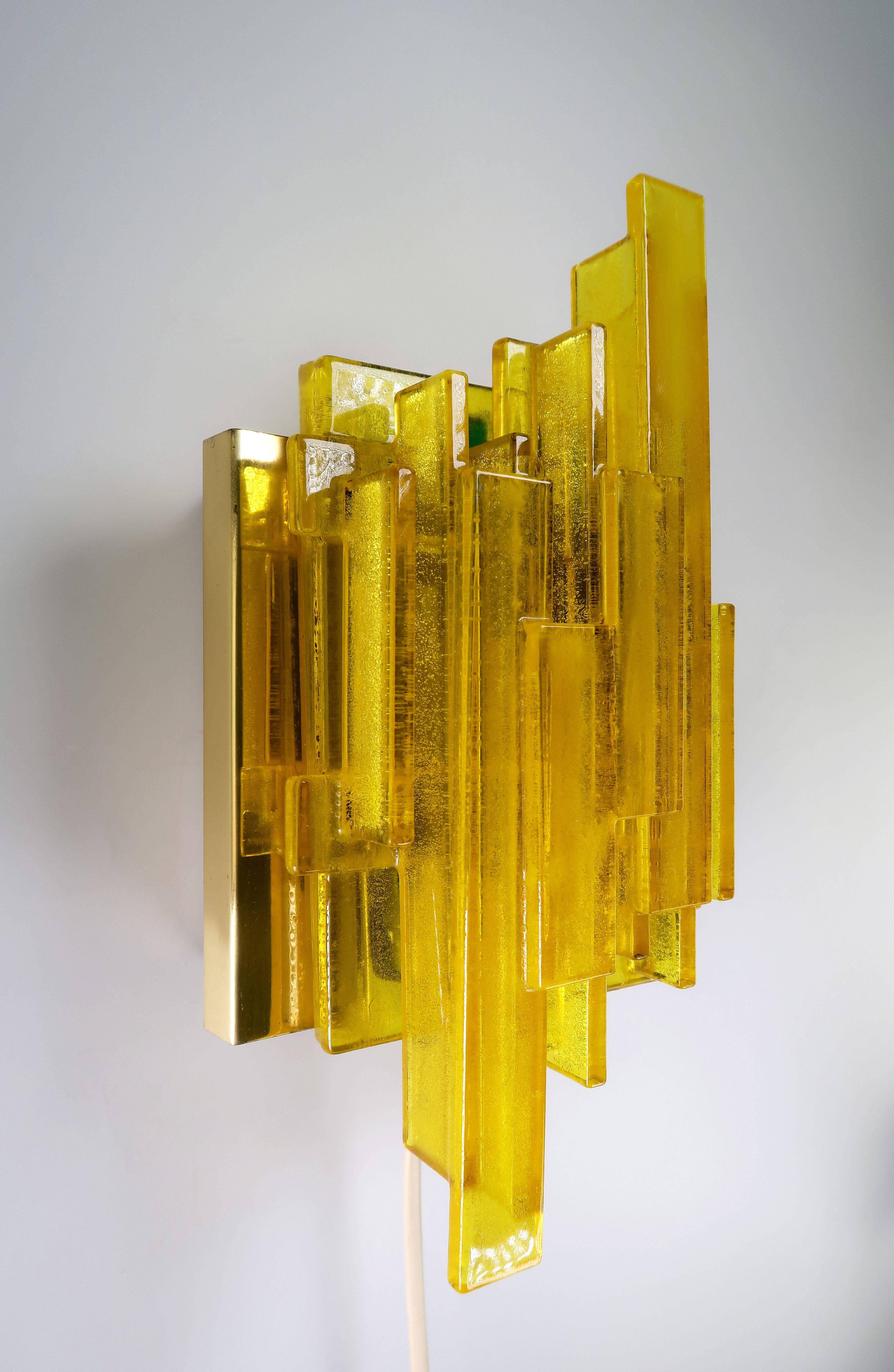 Set of two handmade yellow acrylic Space Age Scandinavian Mid Century Modern geometric wall lights by Danish designer Claus Bolby. Yellow acrylic resin of different shapes and sizes put together over a few elements of green acrylic creating a