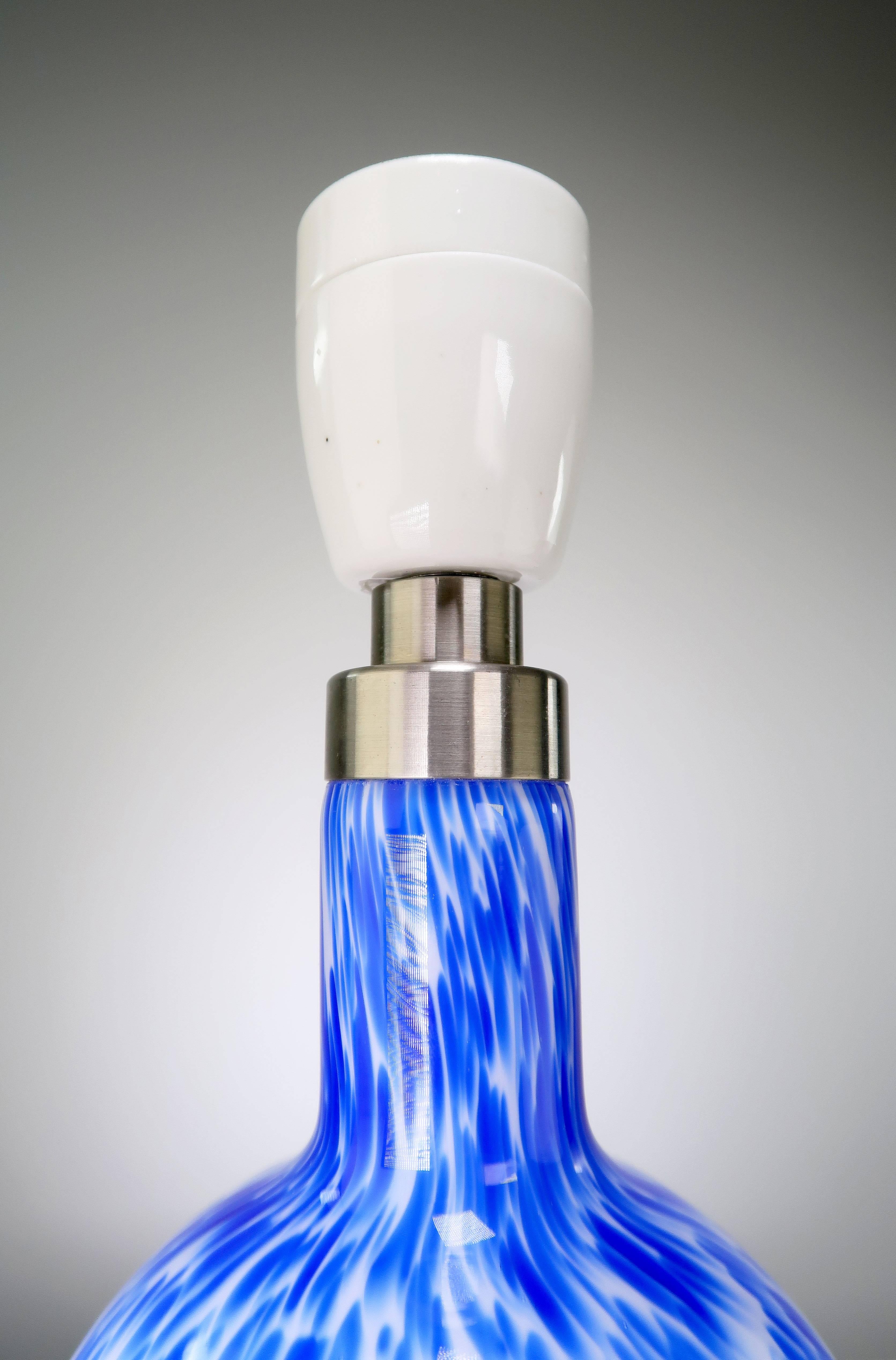 Stunning Danish Mid Century Modern hand blown opaline white glass table lamp with electric blue colorings on the top of the lamp. From the Torino series designed by Michael Bang for Holmegaard, marketed by Royal Copenhagen. Porcelain fitting