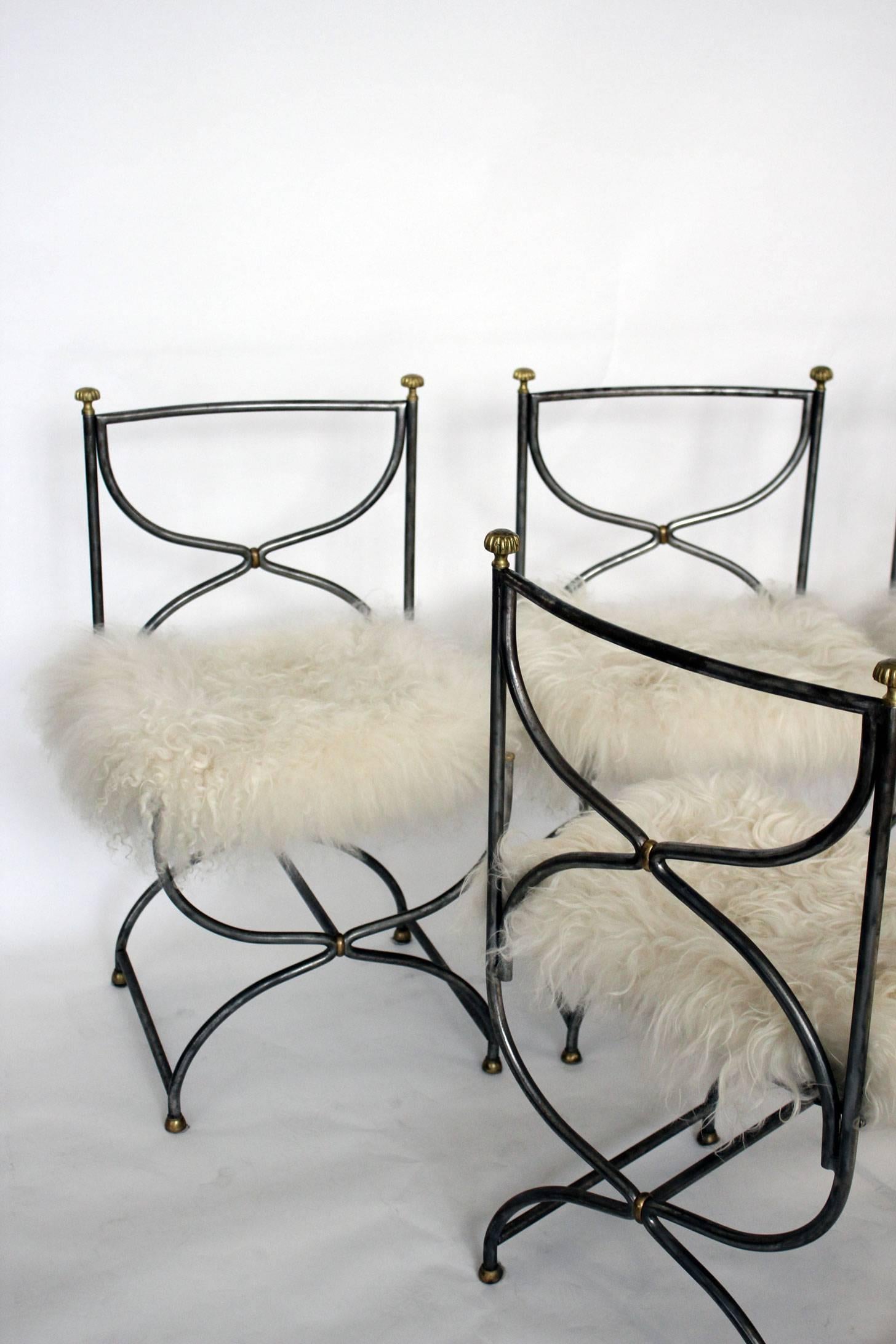 A set of four chairs designed in the style of Maison Jansen and manufactured in stainless steel and solid bronze. The chairs are in original condition and feature a fur cushion, circa 1960s.