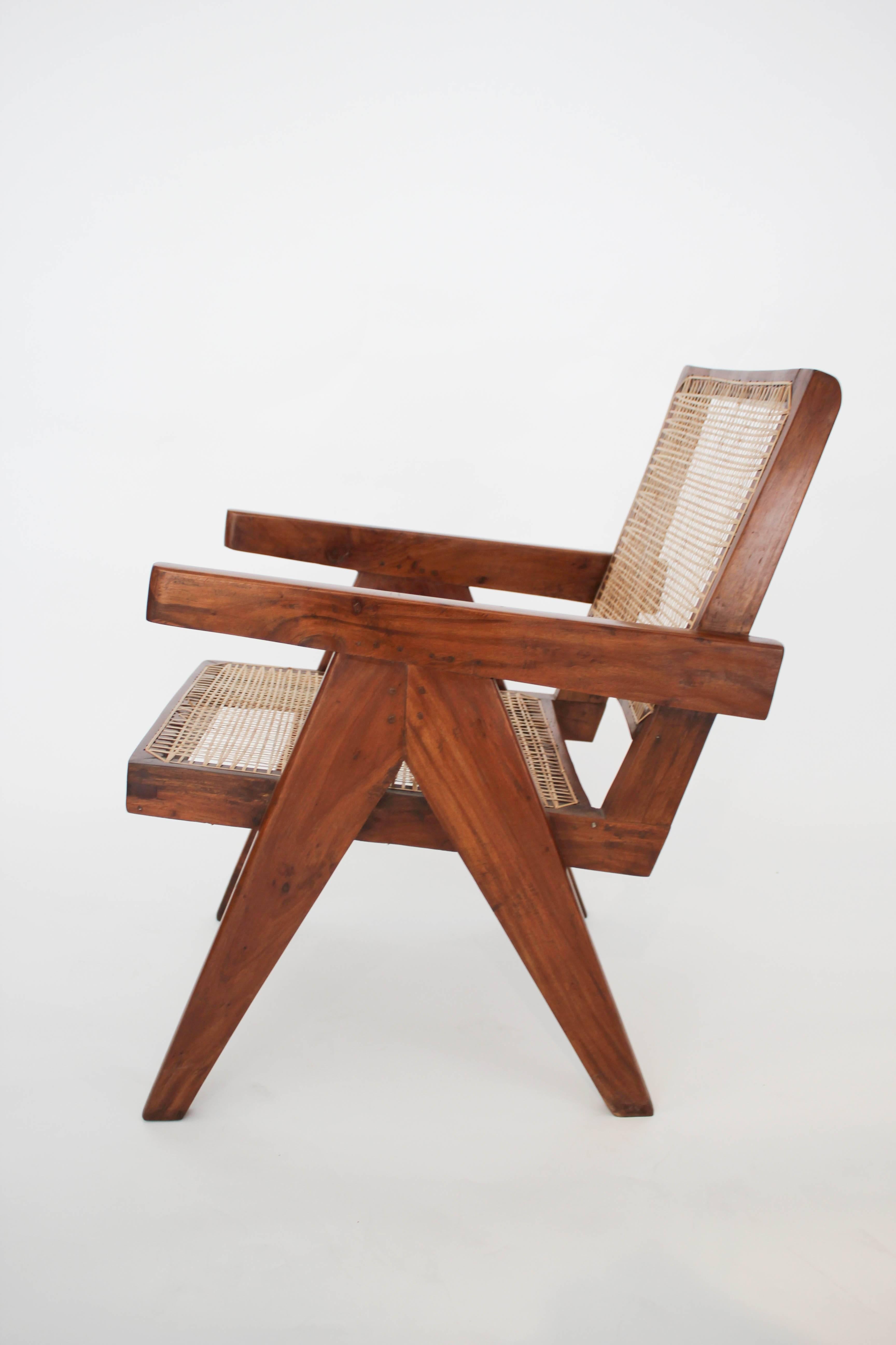 A pair of teak armchairs by Pierre Jeanneret for Chandigarh, circa 1950s. One of the chairs is a fraction longer than the other, a minor difference that does not affect the overall match. Measure: 70cm depth as opposed to 68cm depth of the second