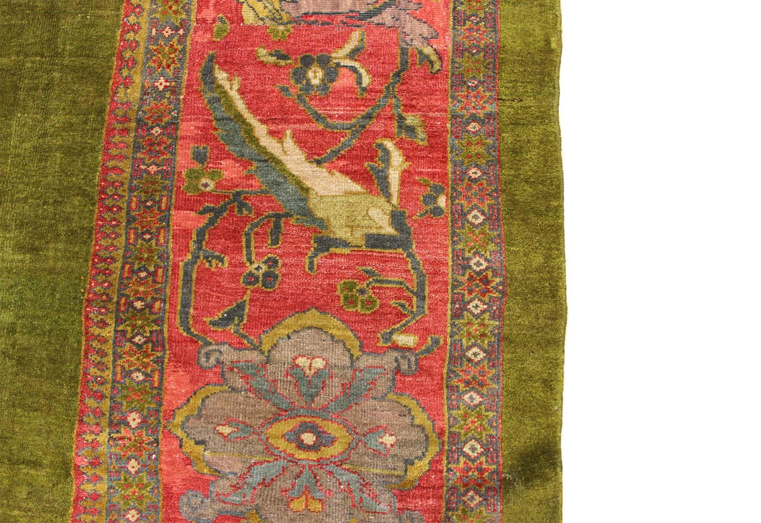 Antique Sultanabad carpet with an unusual grass green, empty field, circa 1870. Expertly reduced from its original size in width and length. Wool pile on a wool foundation.