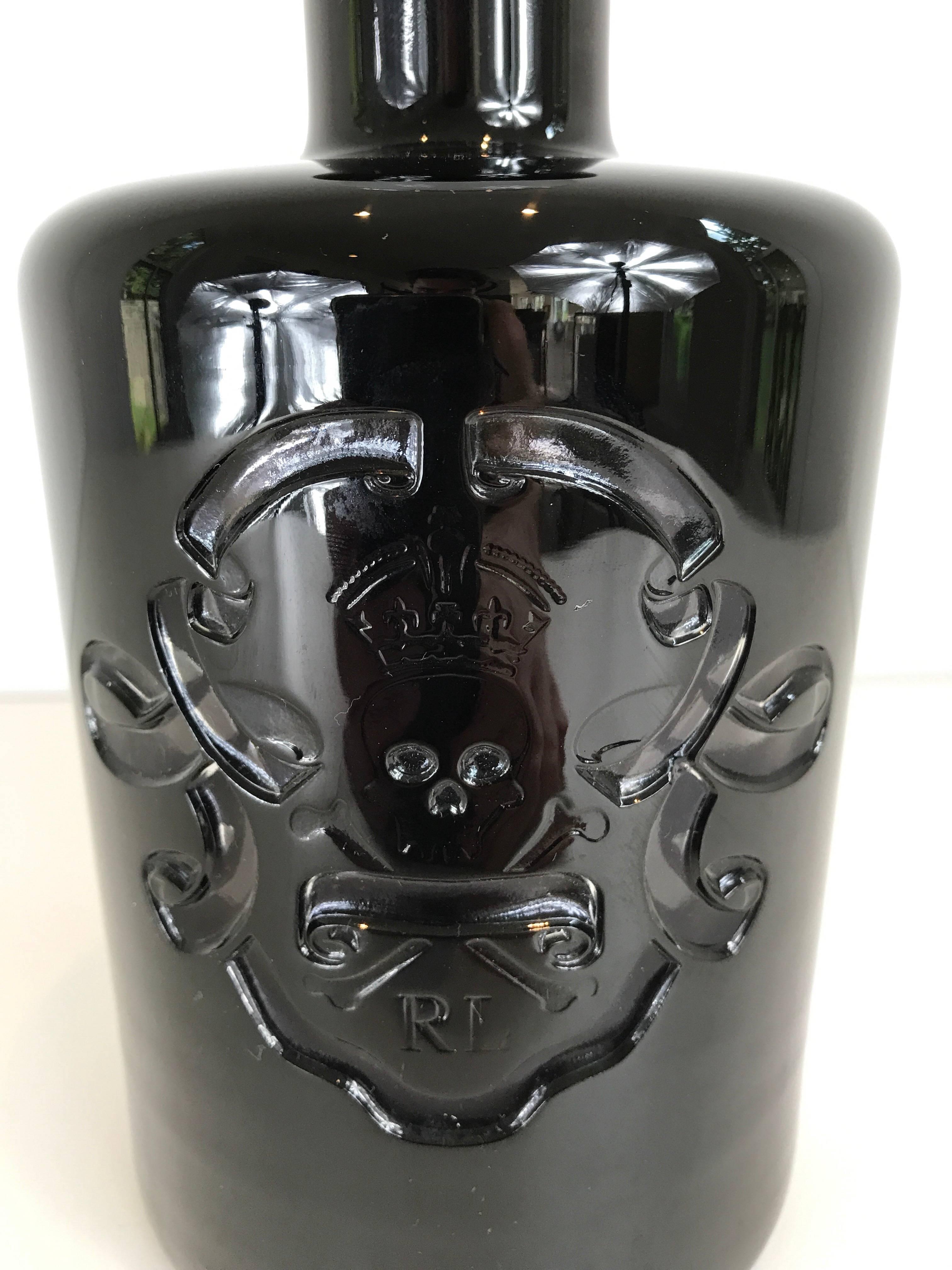 A Ralph Lauren Ayers skull and crossbones decanter. Smoked glass body with clear glass stopper.
