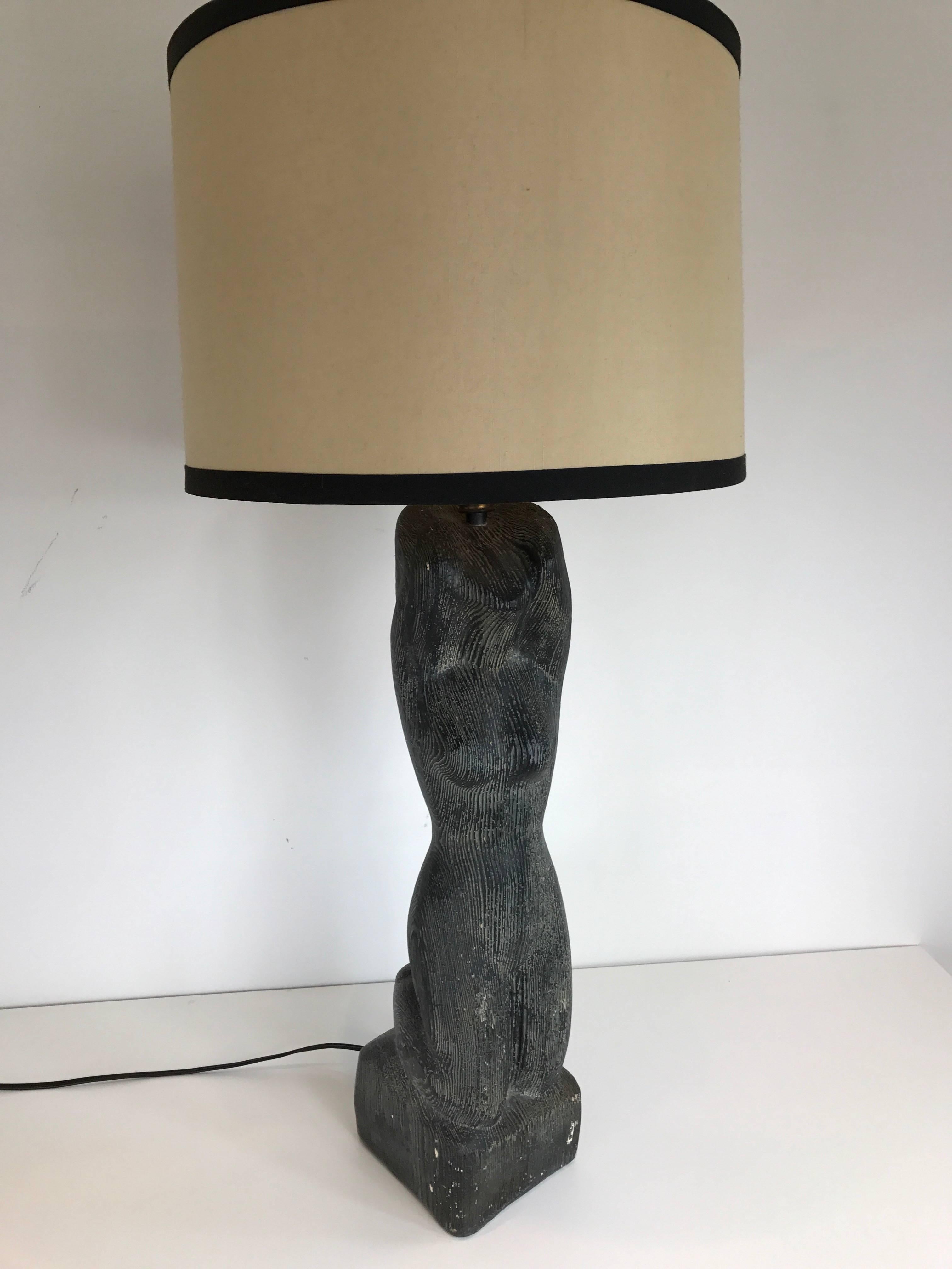 Art Deco plaster figural table lamp of a woman. Dark grey shading with striated indentations. Shade for display purposes only.