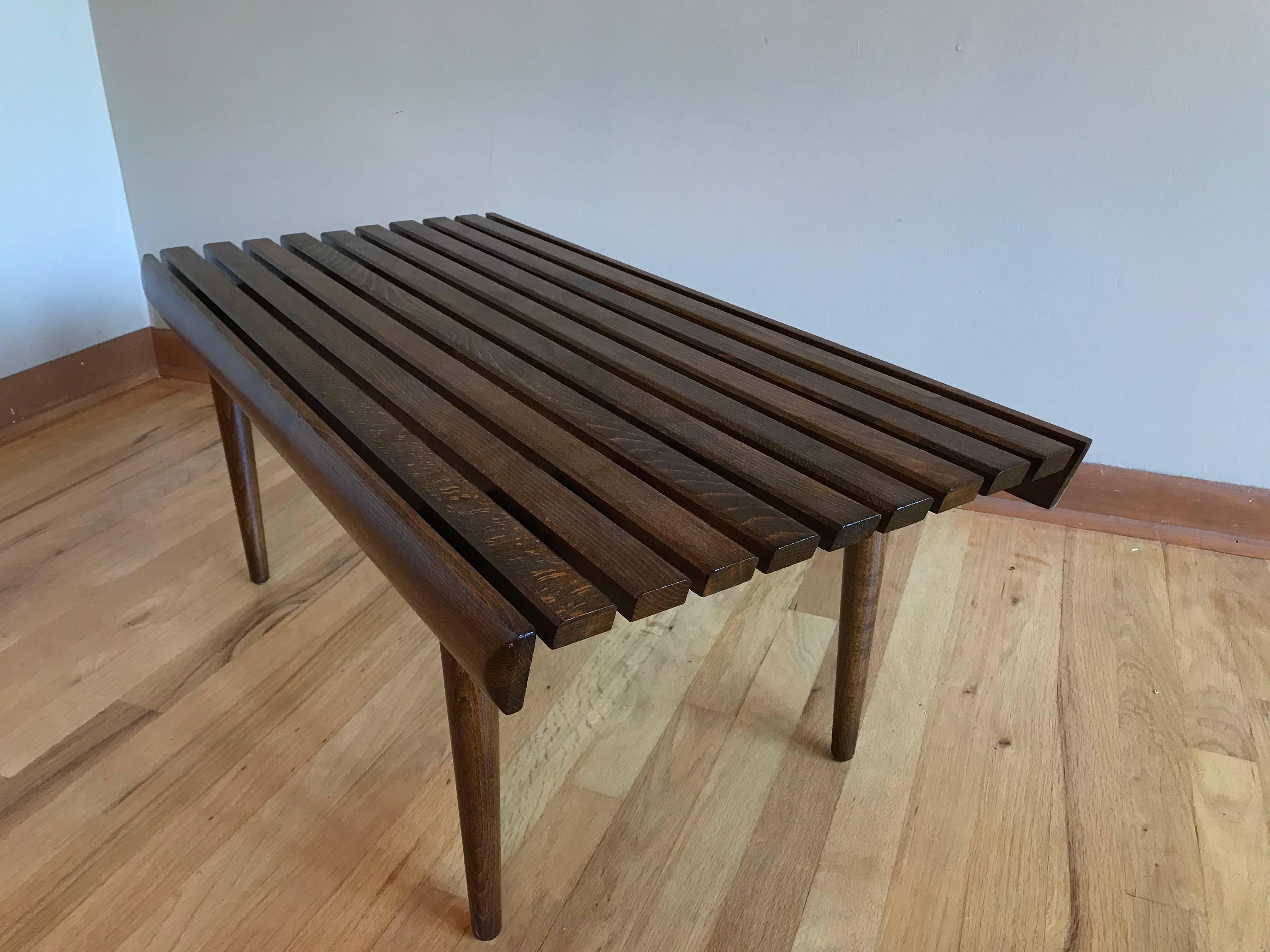 A midcentury walnut slat bench or table. Expertly refinished.