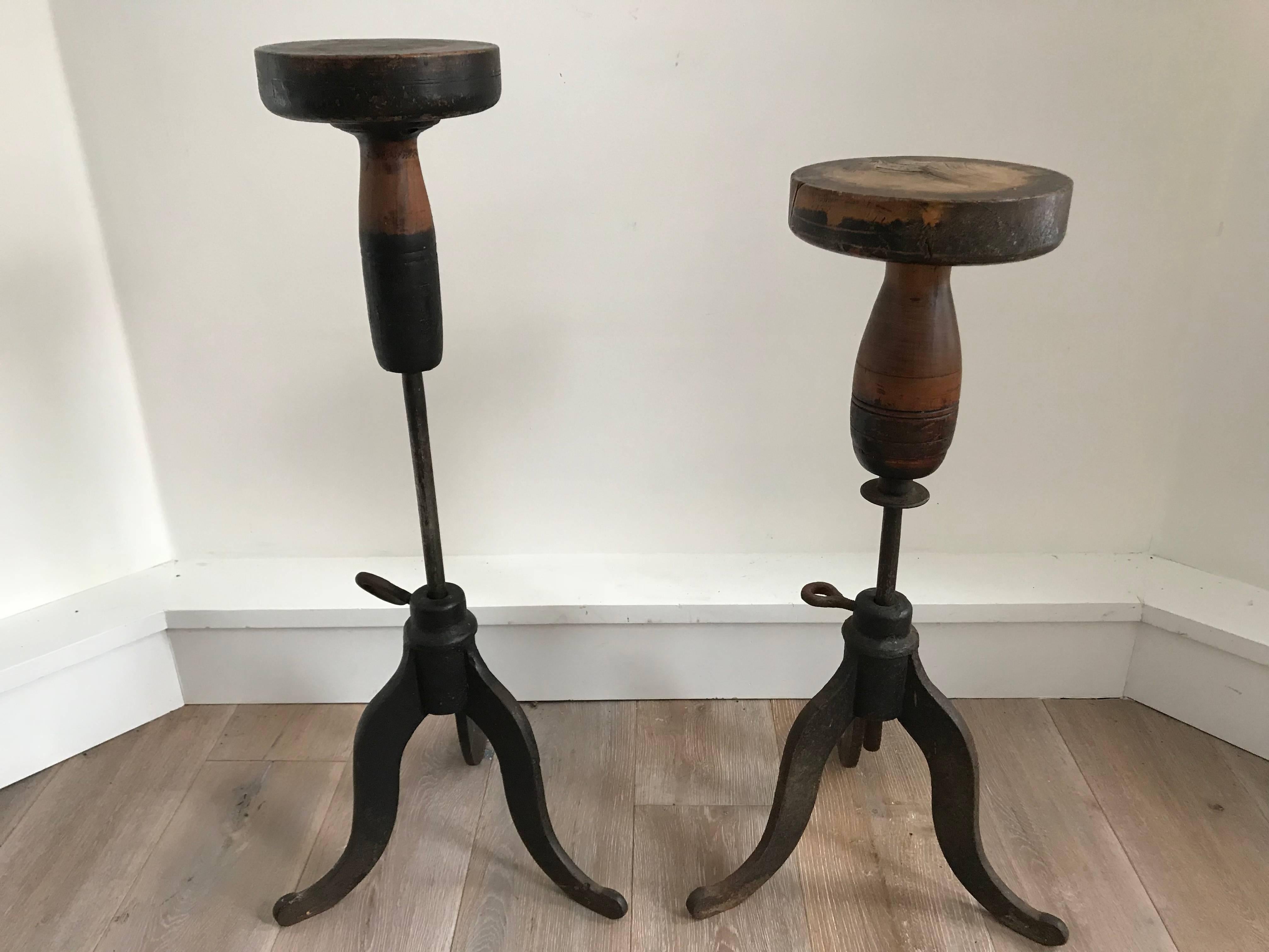 Wonderful antique sculptors stands or pedestal. Revolving wood top on adjustable forged iron base. Great for use as a pedestal to display art. Two available. As shown the largest measures 34.5