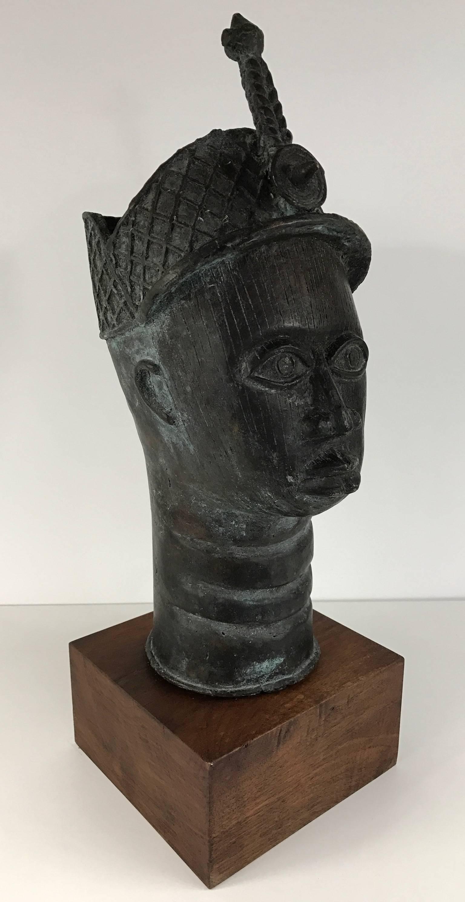 African bronze head of King Oba, ruler of Benin Kingdom. Wonderful etched lines and detailed crown. Mounted on wood base.