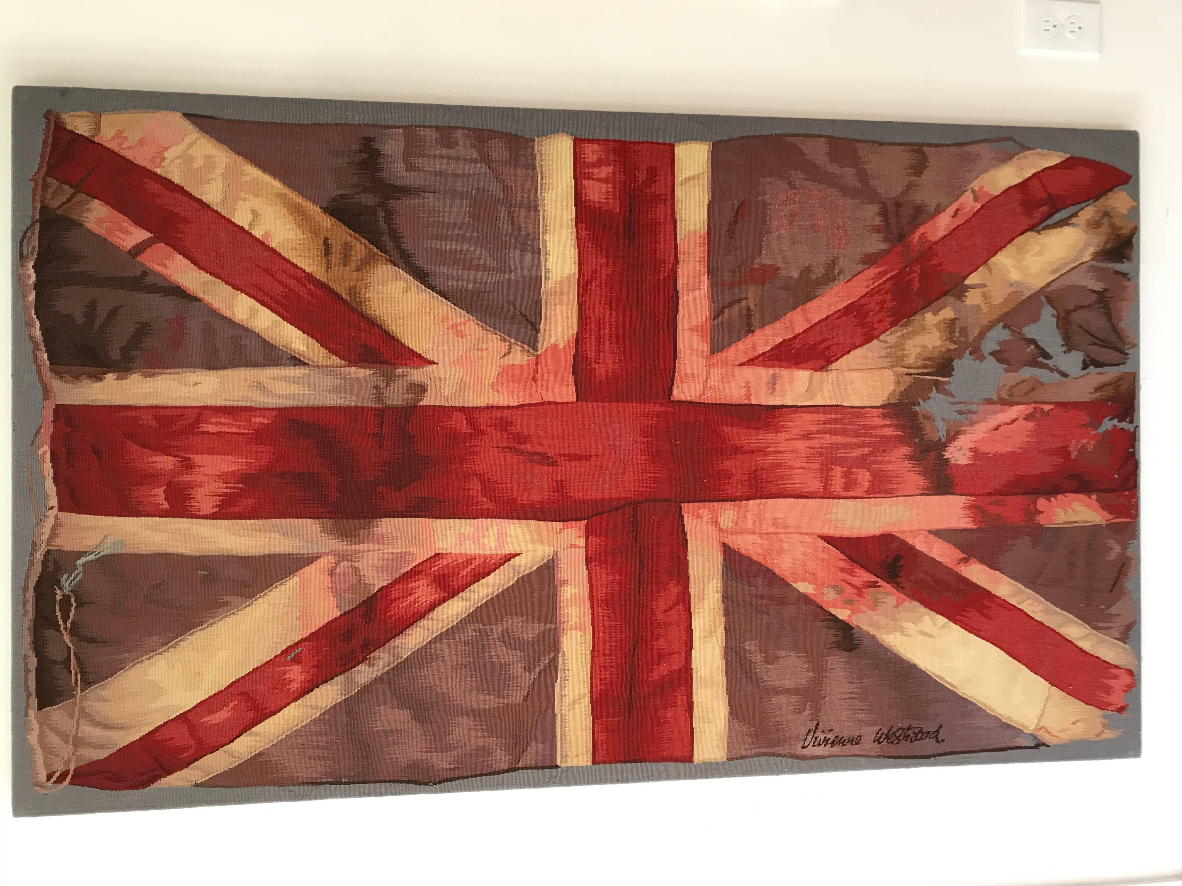 Limited and rare framed Aubusson tapestry of a torn Union Jack by Vivienne Westwood. The "VW" flag is modeled after the designers Autumn/Winter 02/03 "Anglophilia" Collection. Signed in needlepoint by the designer.