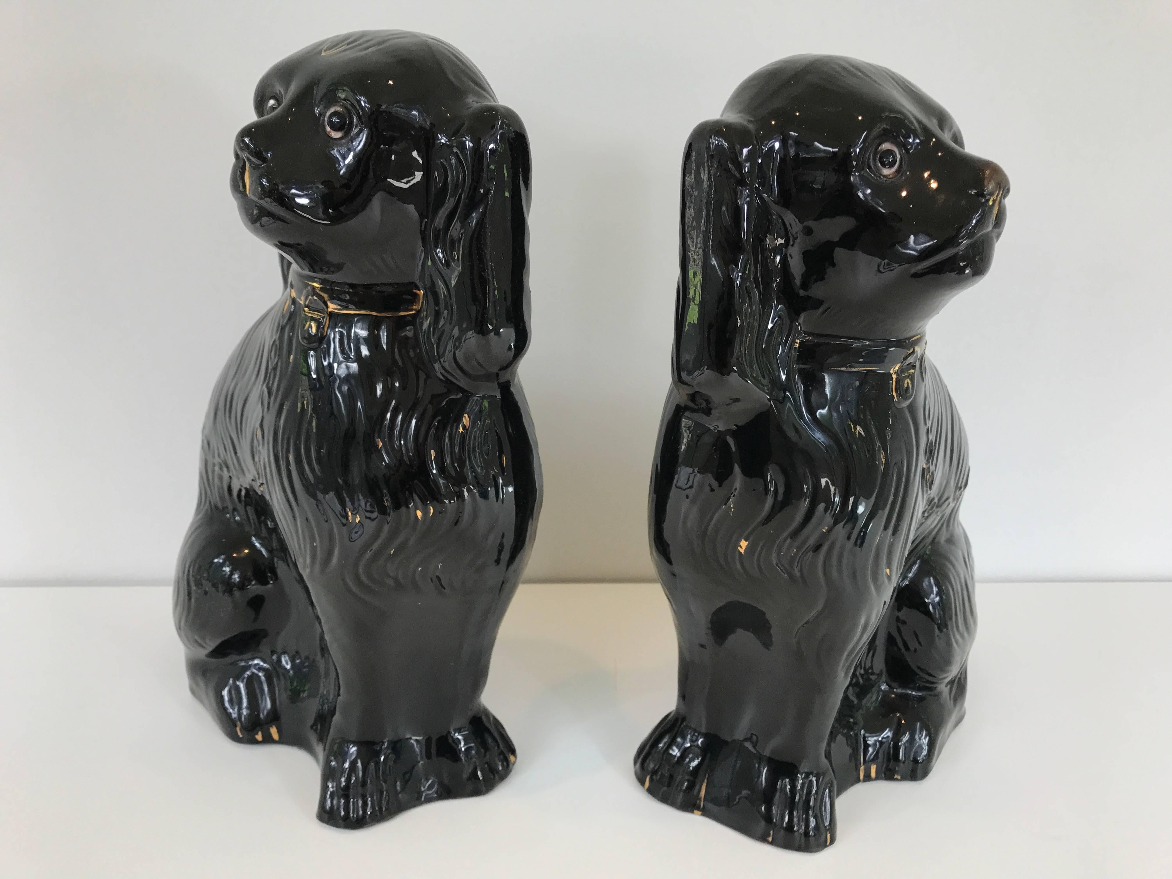 Pair of 19th century Staffordshire dogs in rare black glaze with gilt highlights and glass eyes.