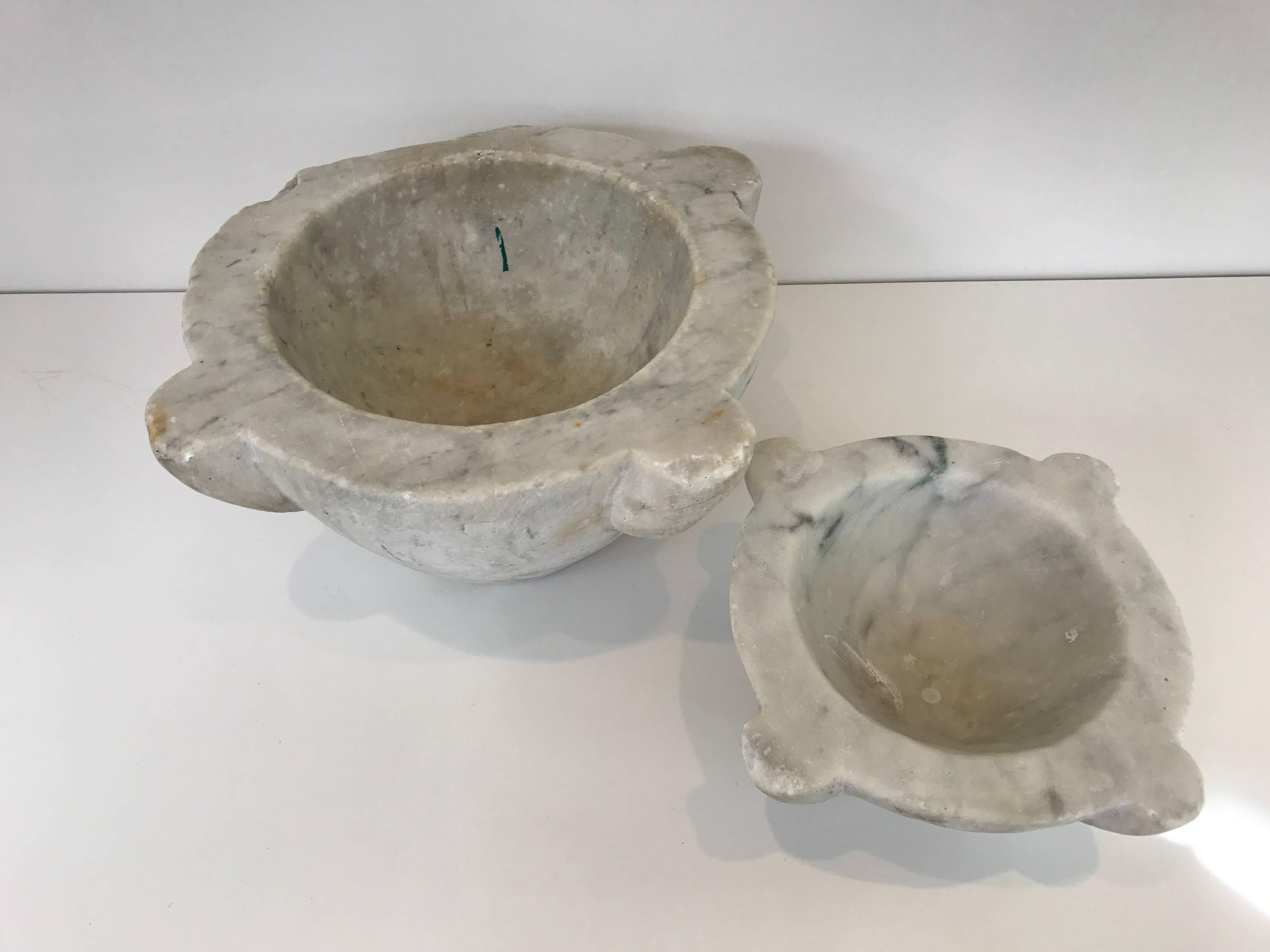 Wonderful large-scale pair of 18th century Italian marble mortars. Great patina, loss to one corner of large mortar. Heavy and solid construction.
Large mortar measures 13