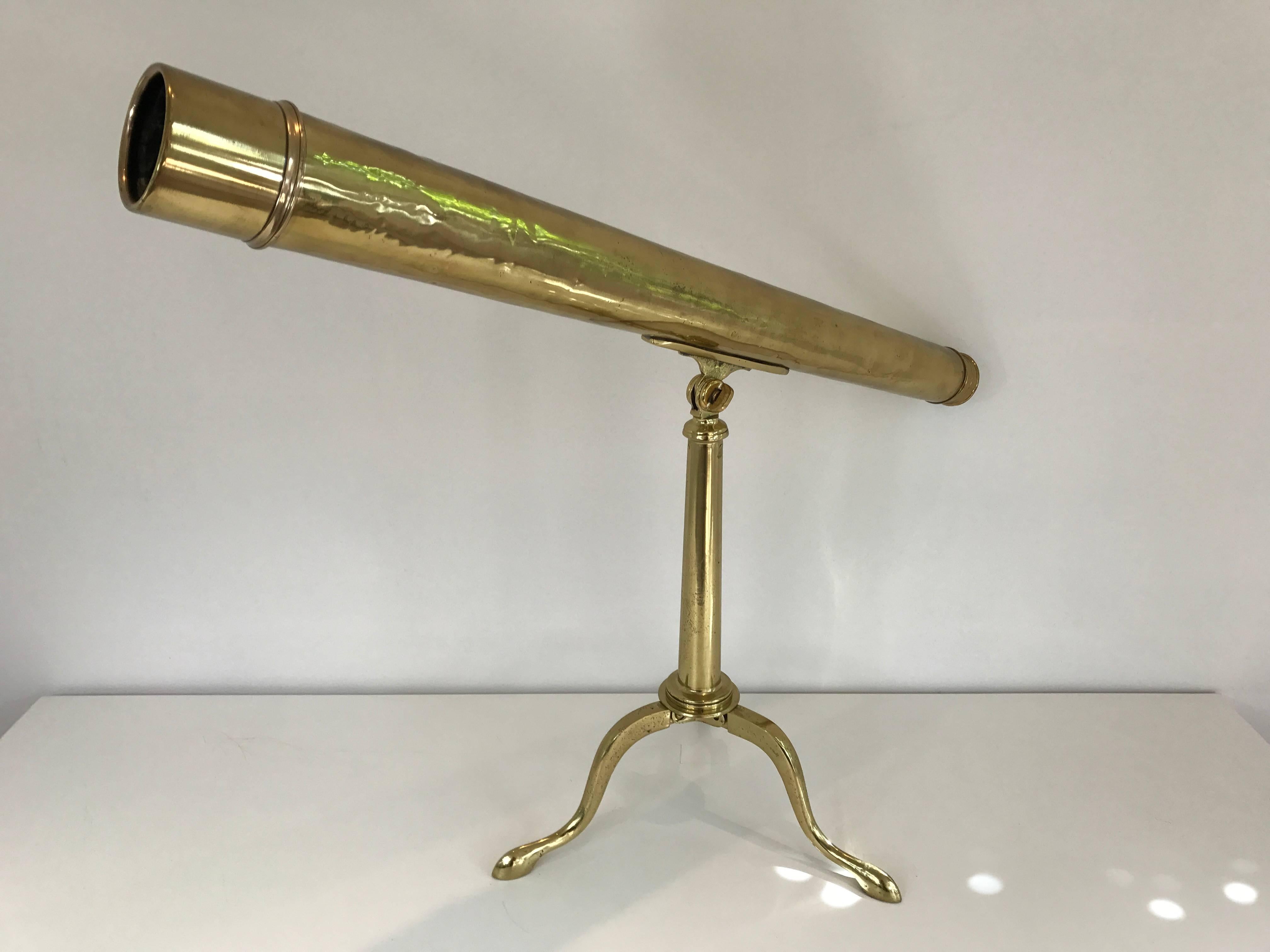 A solid brass 19th century English telescope on collapsible brass stand. Lens is currently not in working order but would make a lovely addition as a decorative object.