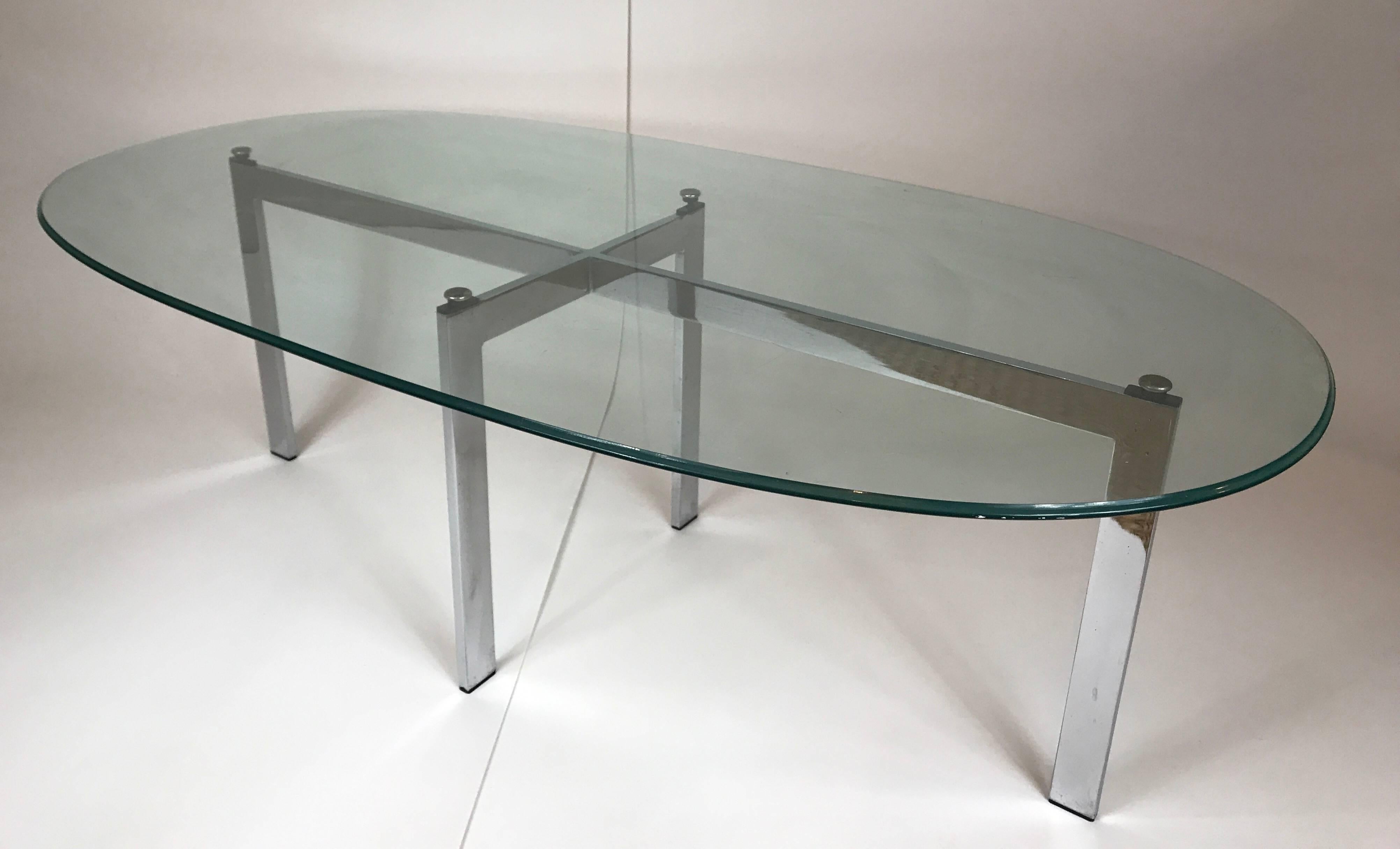 1970s chrome base cocktail table with thick oval beveled glass top. Base measures 42