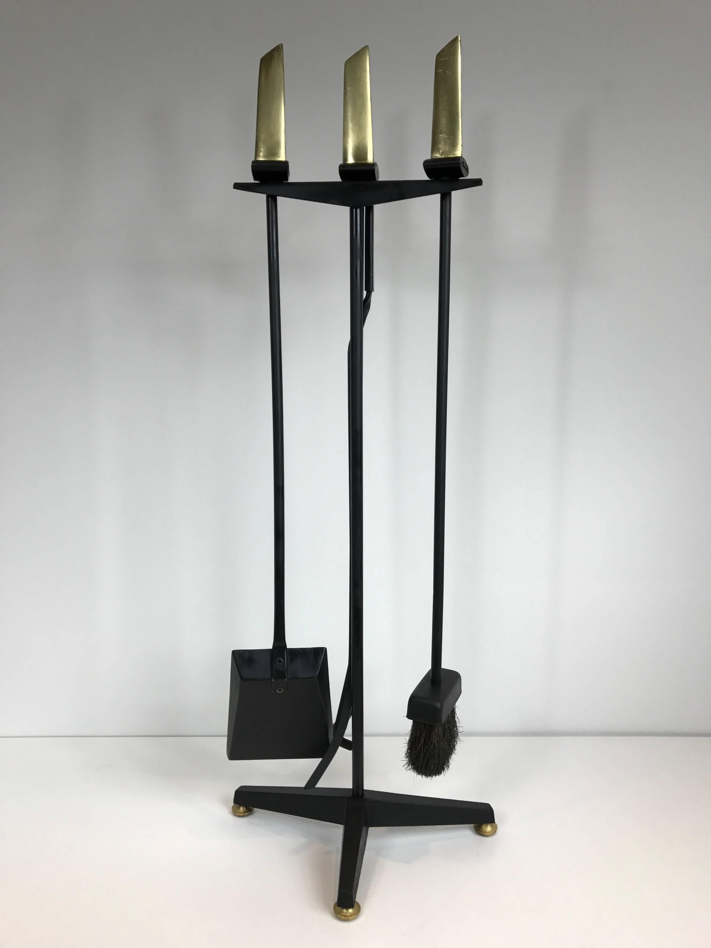 Donald Deskey iron fire tool set with brass handles.
