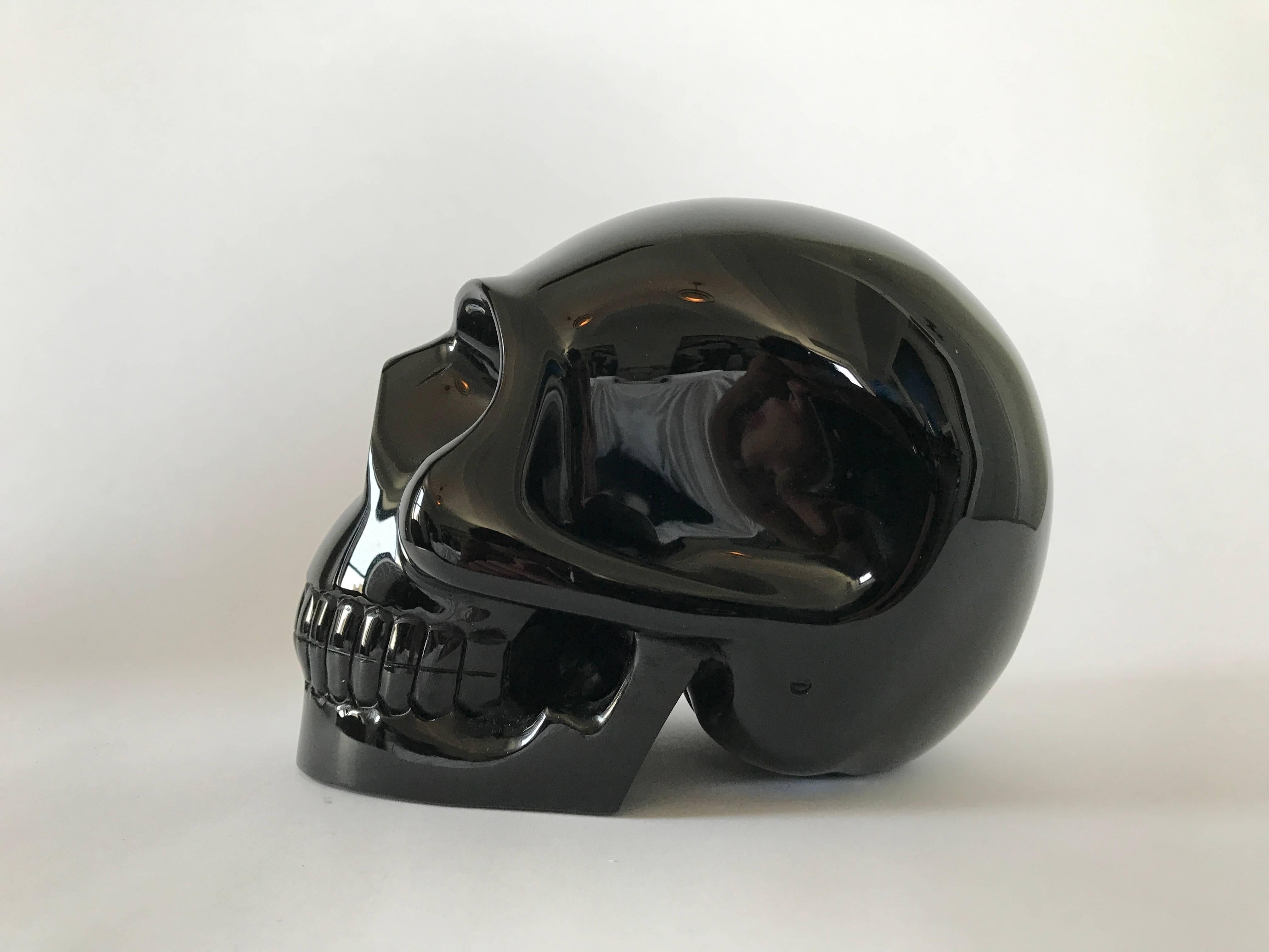 A carved black onyx skull. Signed 