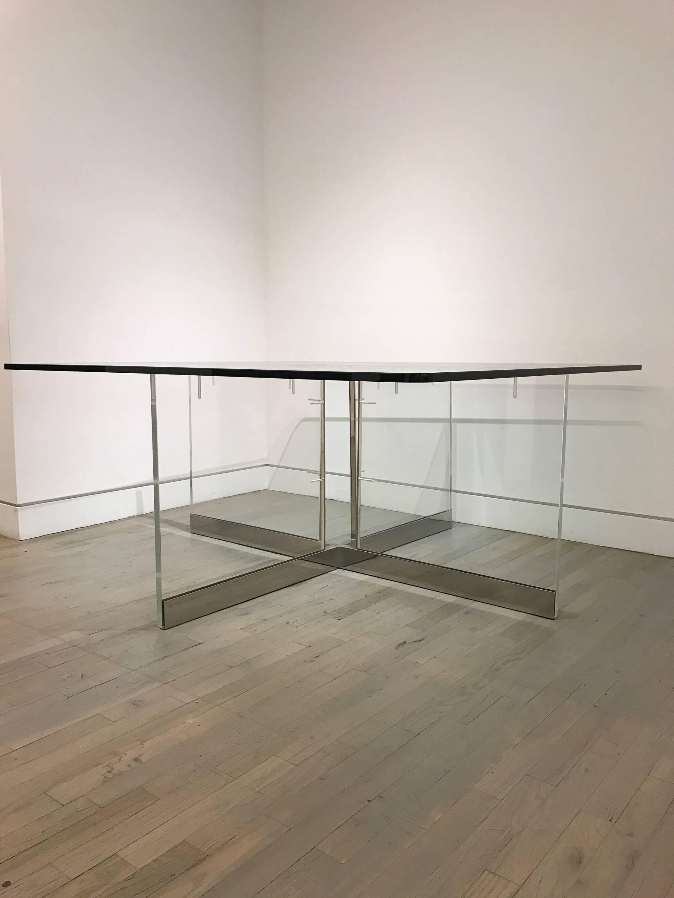 A large custom Lucite and chrome dining table. Thick Lucite base with glass top. Solid and heavy construction.