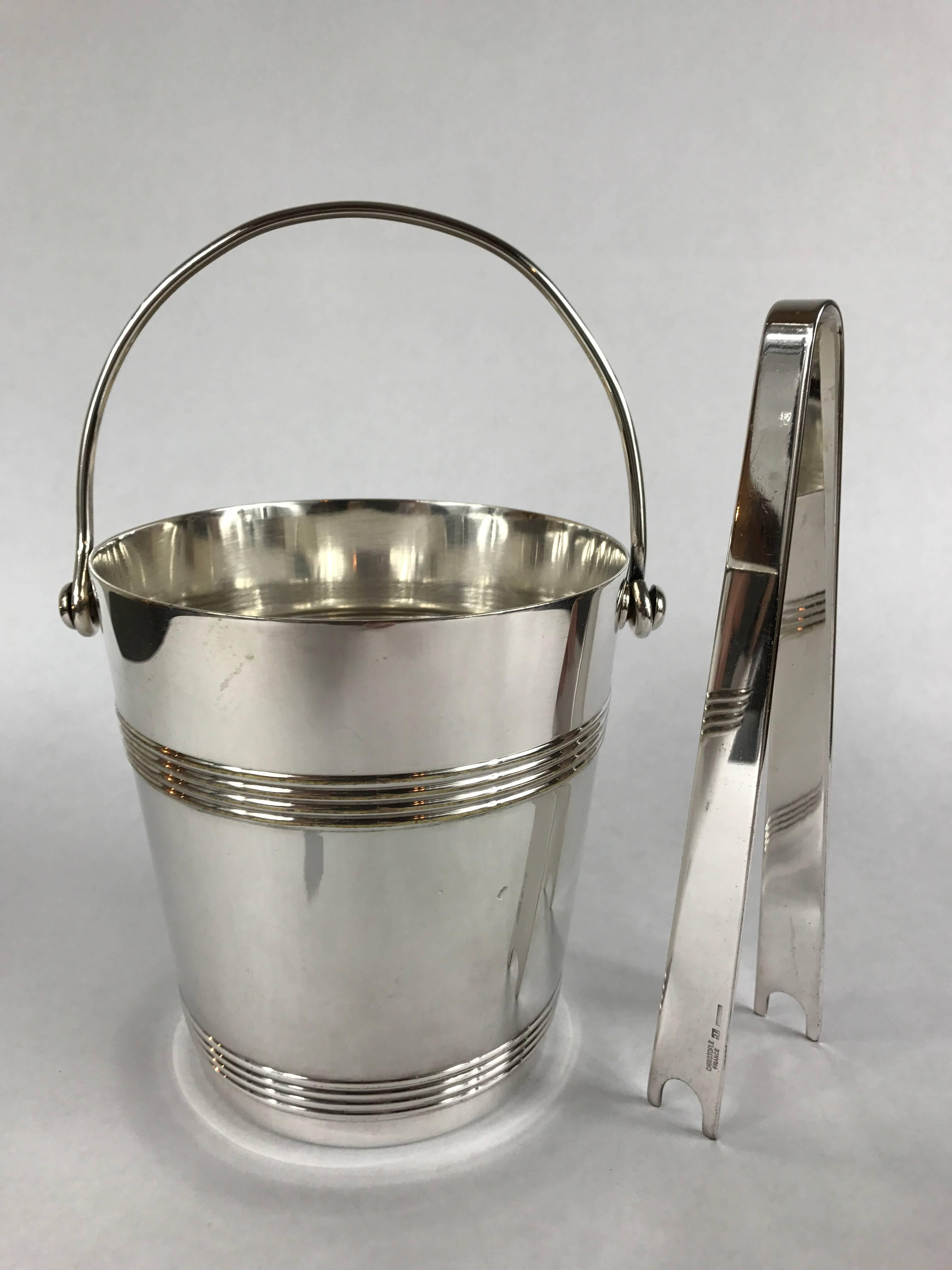 A Christofle handled silver plate ice bucket and associated silver plate tongs.