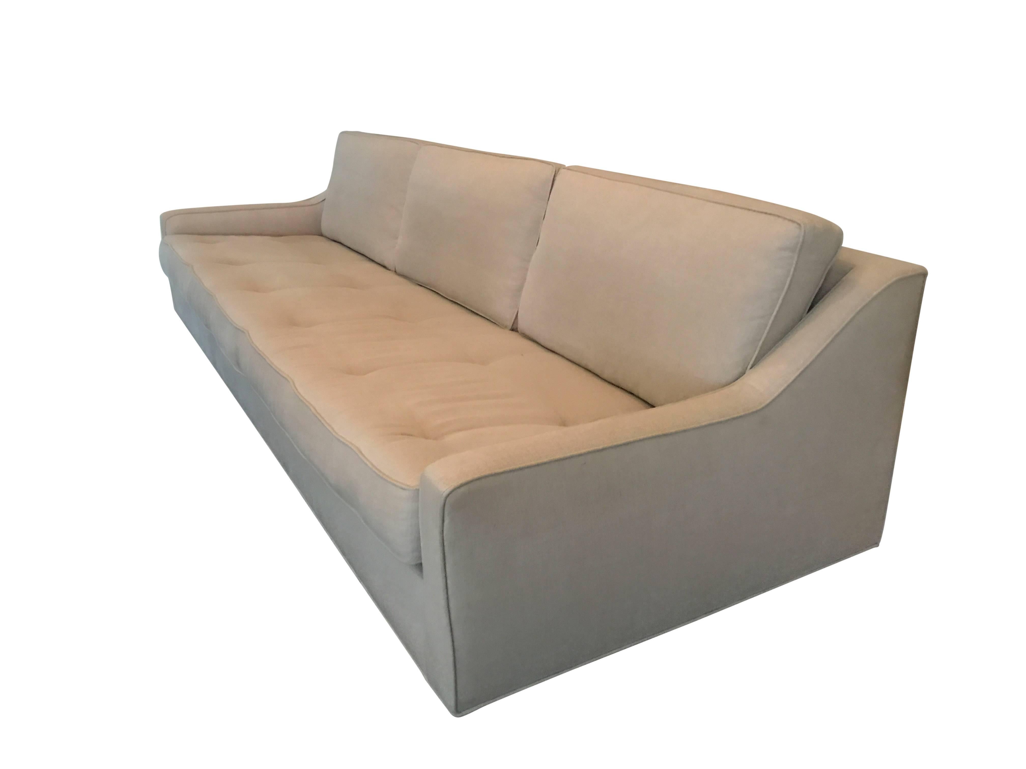 A sleek Danish modern linen upholstered sofa by Selig. Tapered legs and newly upholstered.