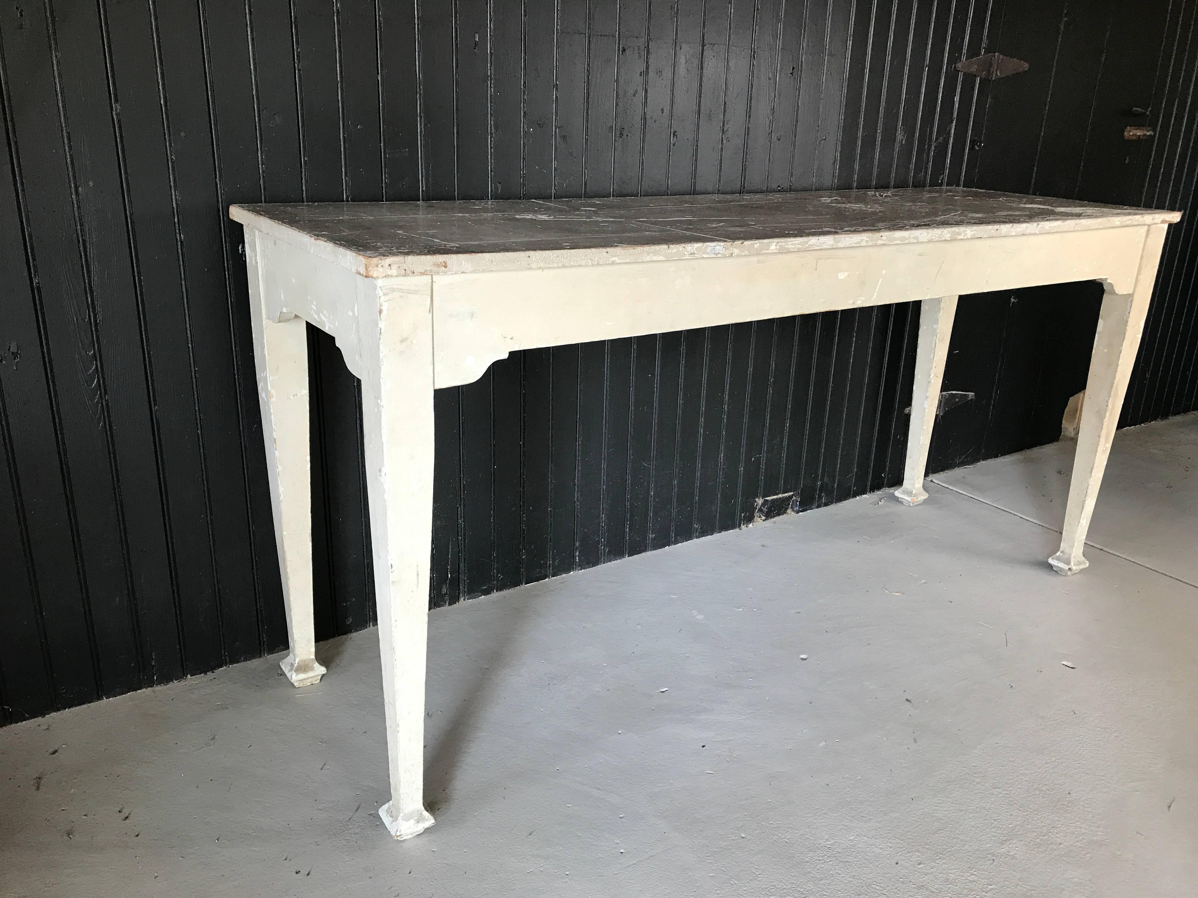 Interesting antique French massage table, now as a console. One end lifts for use as a headrest. Presents wonderfully as a table and is finished on all four sides.