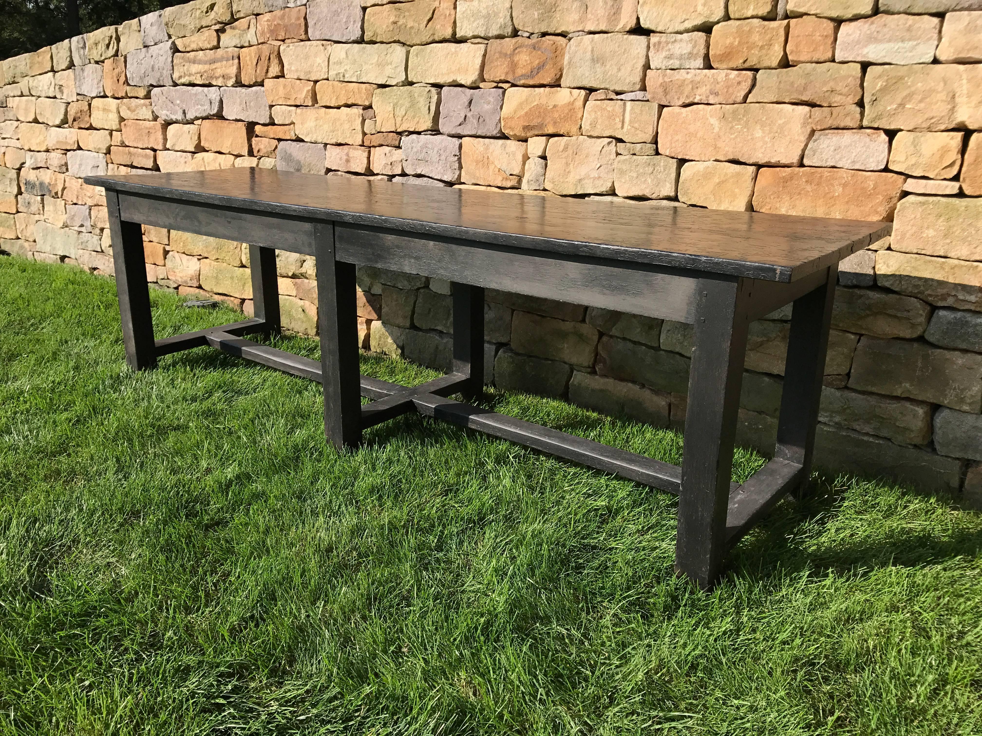 A black painted 19th century farm or work table with a distressed black painted finish. Large scale. Would work well as a work table or kitchen island.