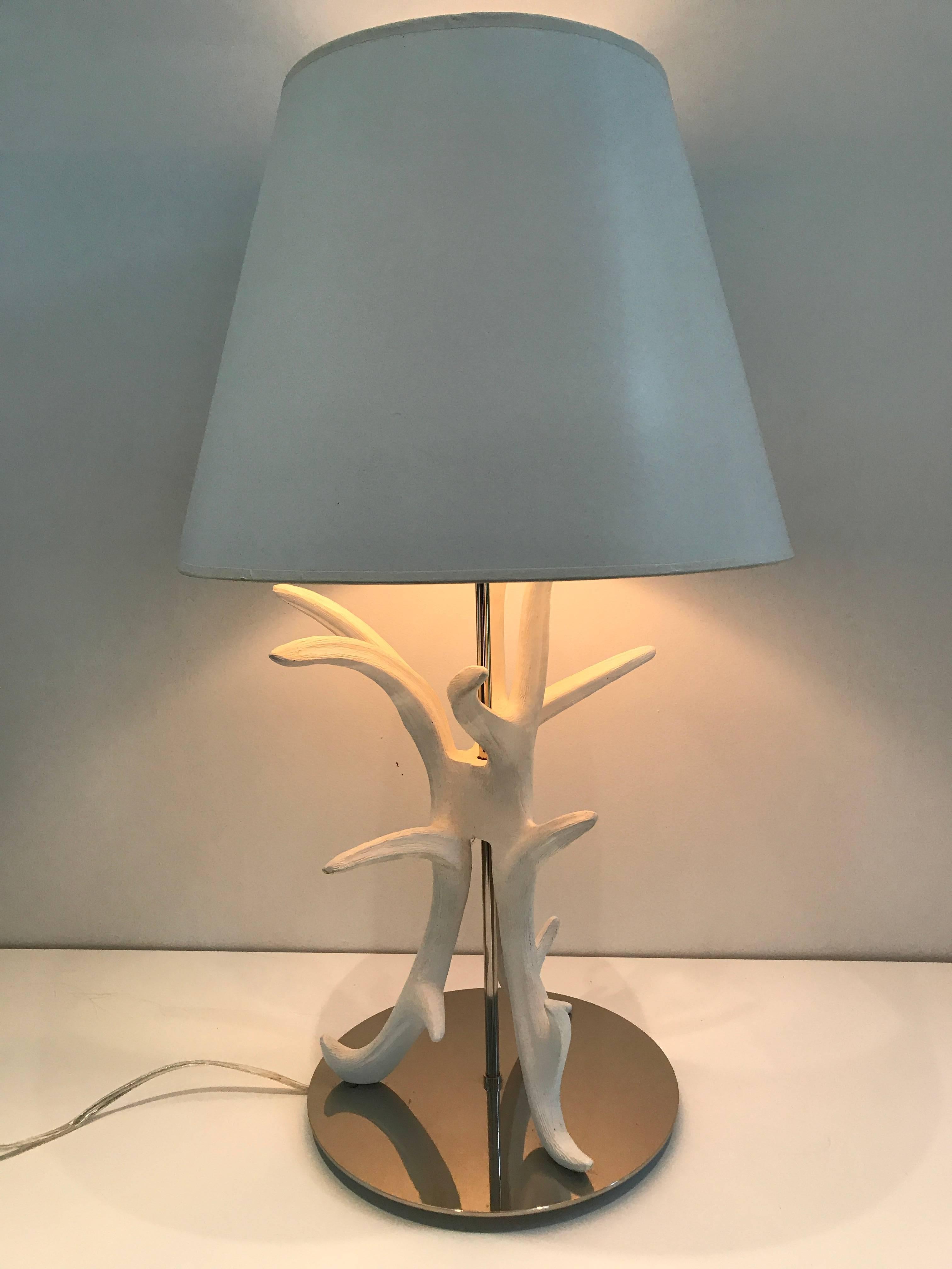 A pair of white painted faux antler table lamps mounted on circular chrome base. Shade for display purposes only.