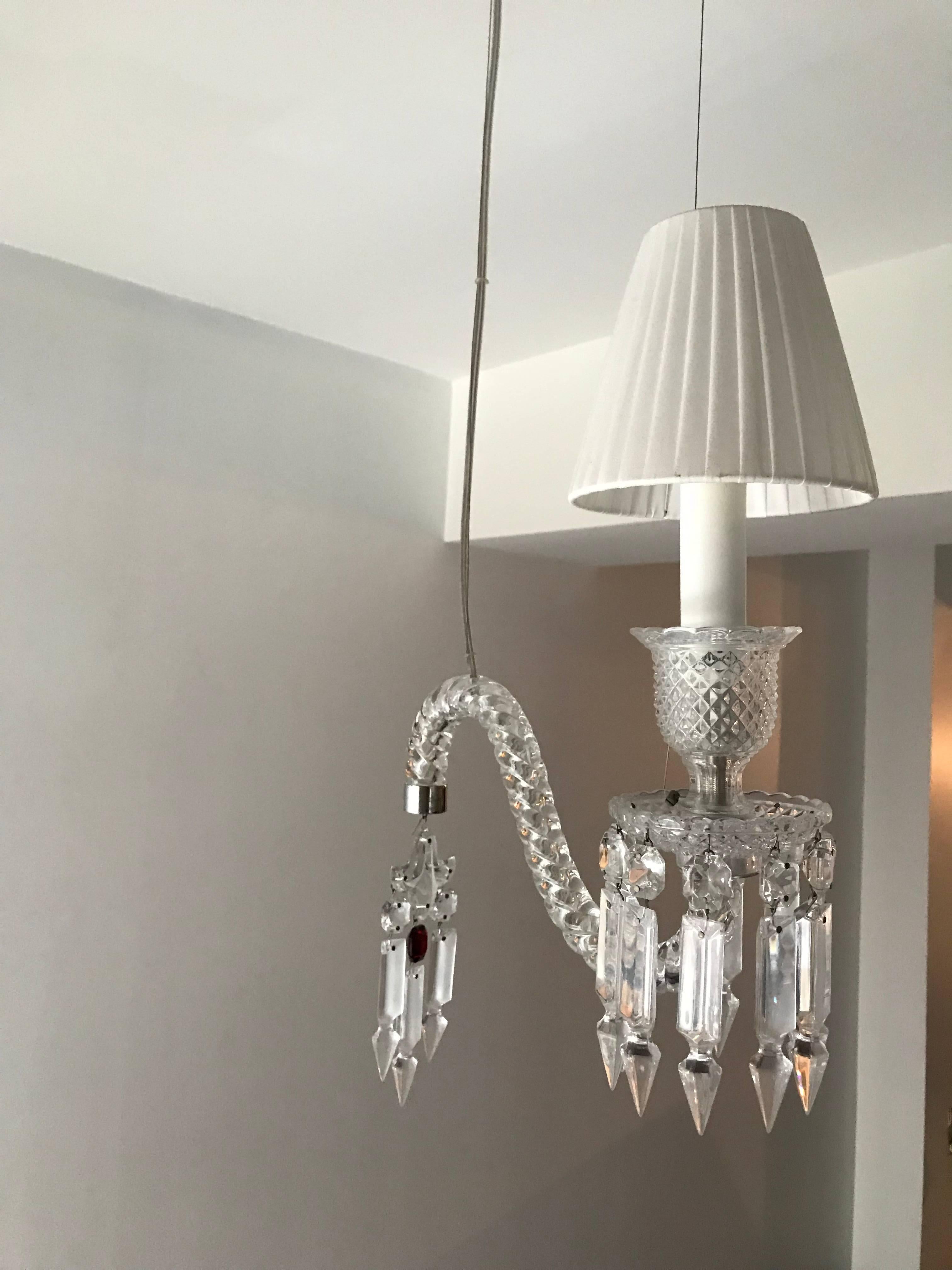A pair of handcrafted full-lead crystal Fantome sconces designed by Arik Levy for Baccarat. Hung from silver metal ceiling mount as shown. Drop height can be adjusted. 
 