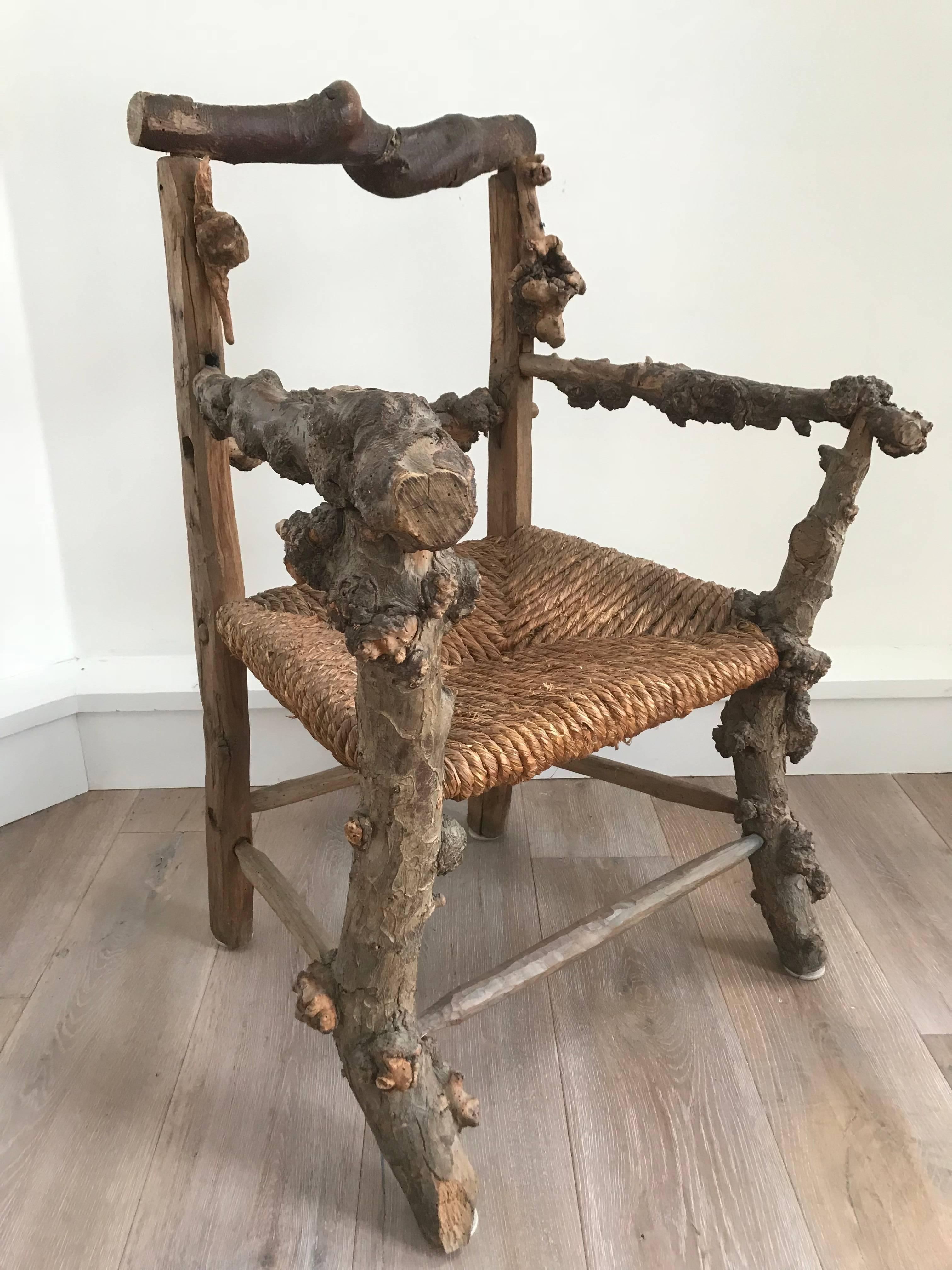 Unique and interesting early 19th century root chair with rush seat and hand-carved frame.