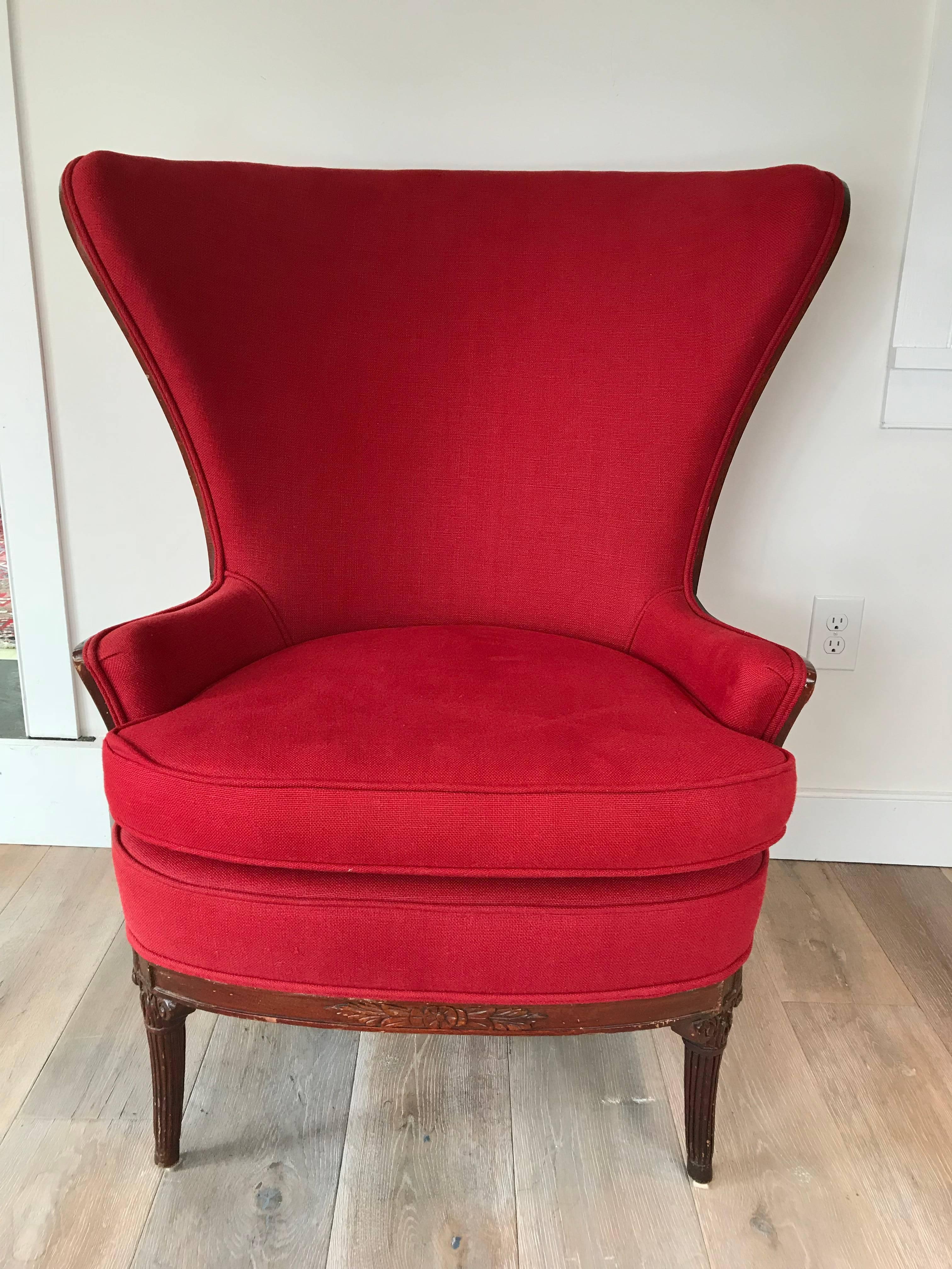 A late 19th century French butterfly wing chair upholstered in red cotton canvas.