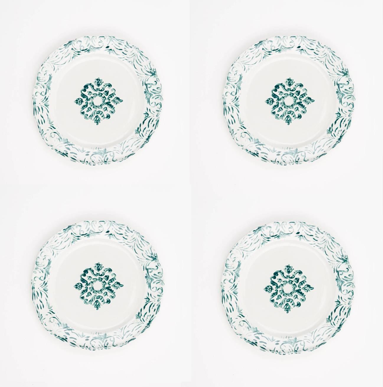 Hand printed green and white floral dinner plates, set of four.
These ceramic plates are handmade and hand-painted by Zsuzsanna Nyul. They are high fired stoneware pieces with different designs created using an unique technique. The bottom of the