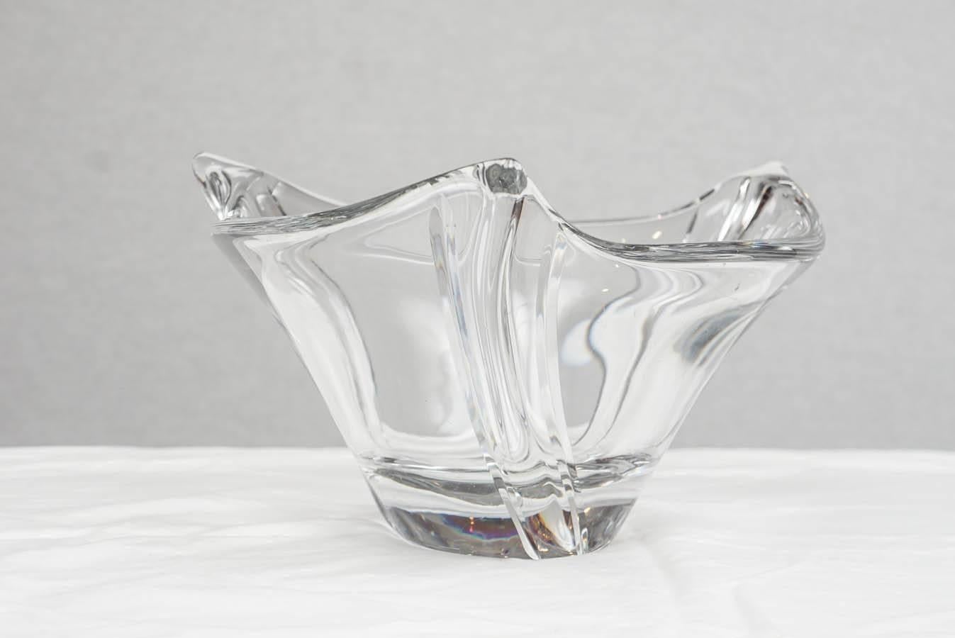 French lead crystal bowl in an elegant form that works in both modern and traditional settings. The heavy glass is very sculptural and is signed on the base with the etched Daum mark. Working as well on an entry hall console as it does on a holiday