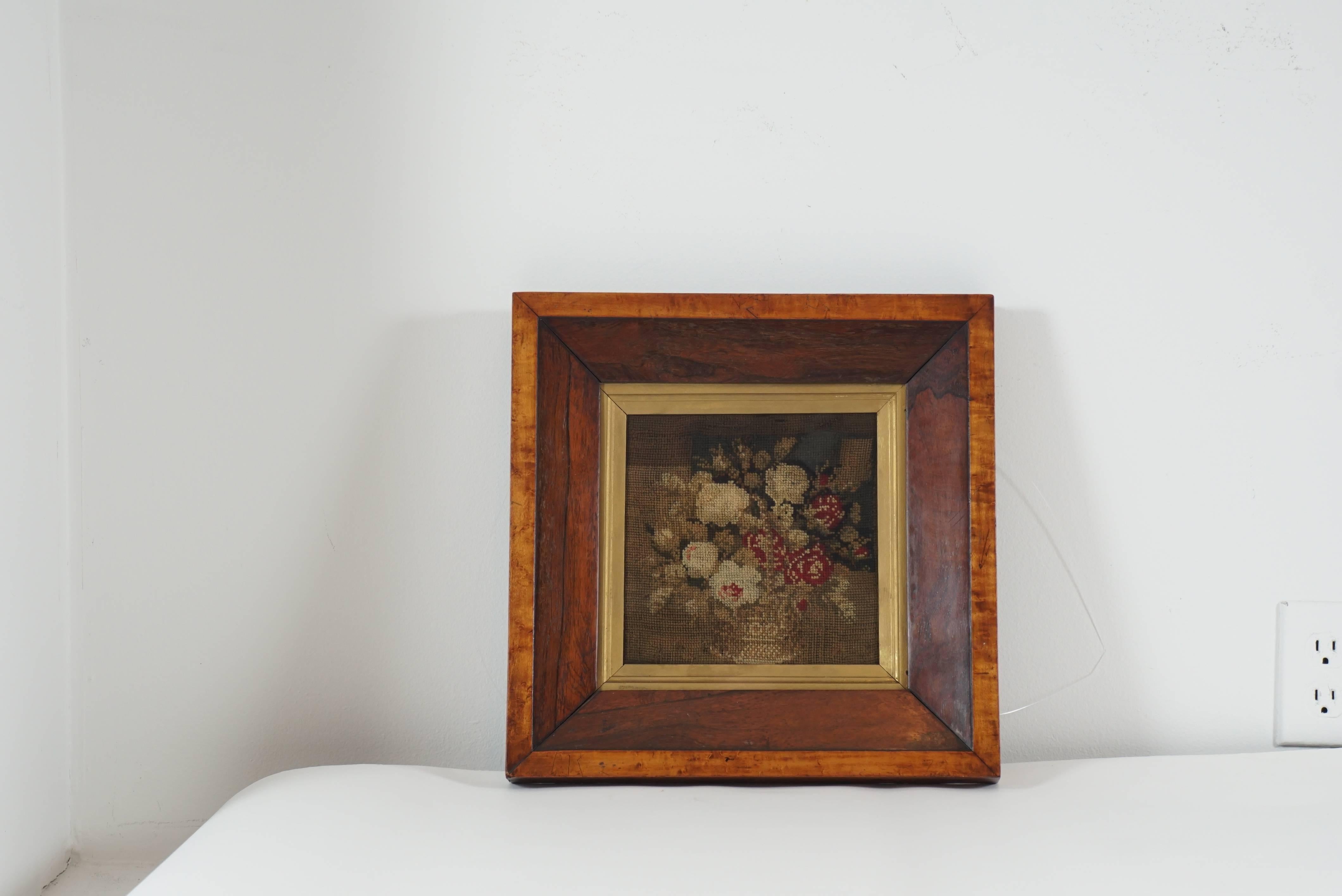 Fabulously framed 19th century needlepoint in original frame. The piece is backed with worn newspaper that is dated 1879. A beautiful addition to a traditional setting.