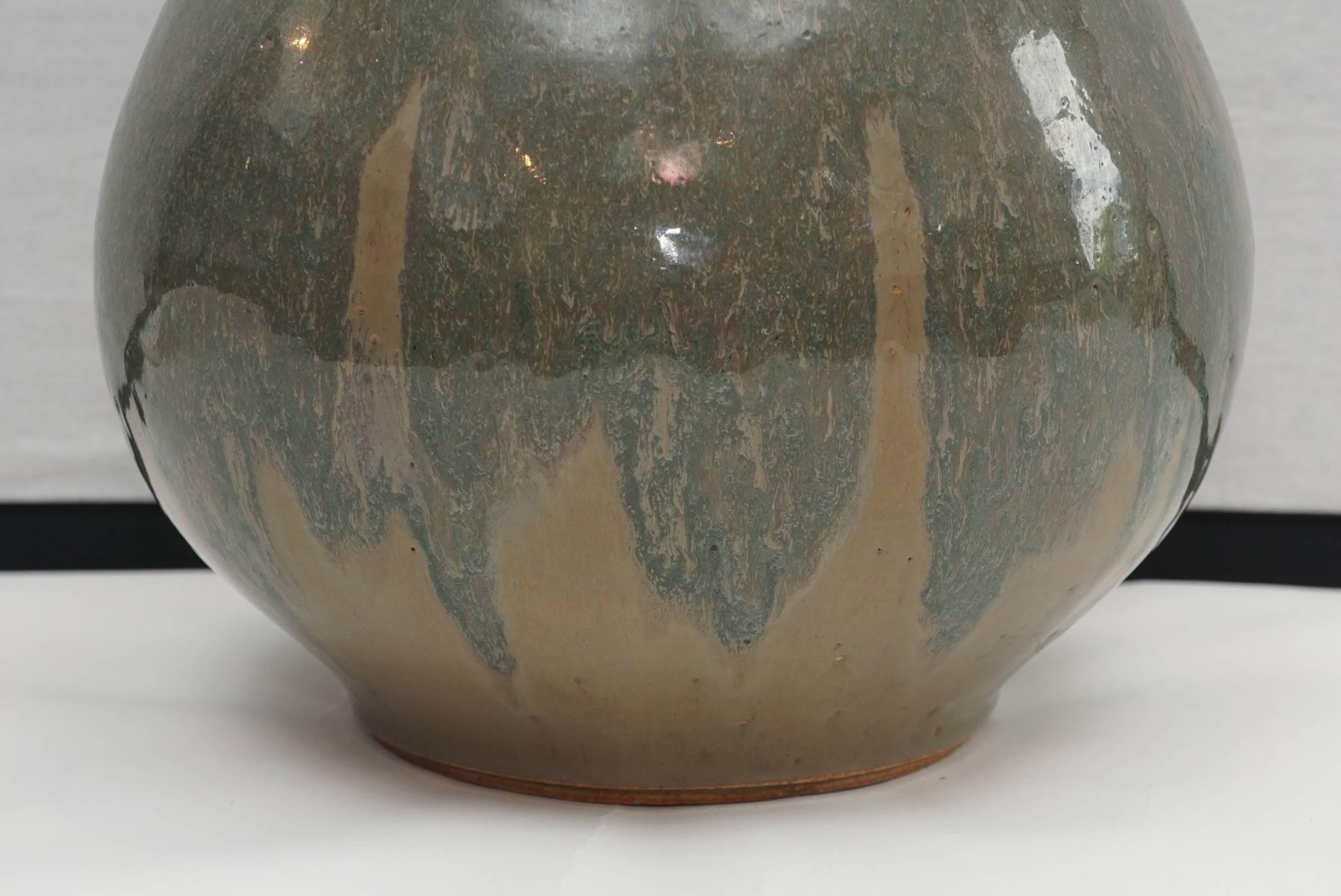 Strong and striking impression made by this substrative piece of late 20th century art pottery. Wonderful glaze that blends from blues to grays and browns. Works wonderfully with a neutral design palette on a hearth, fireplace or floor.