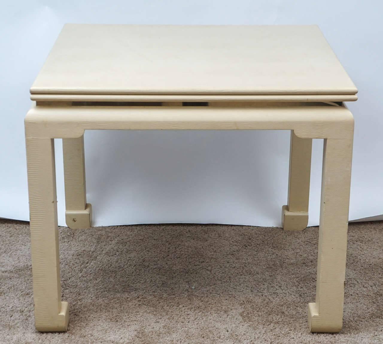 Wonderful flip-top game table expands to accommodate six-eight diners. The embossed Ivory leather is in fair condition with occasional scuffs and minor losses. Can be restored upon request. Subtle suggestion of an Asian aesthetic to the form of the