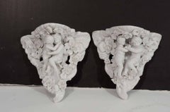 Two Porcelain Wall Shelves with Affectionate Cherubs