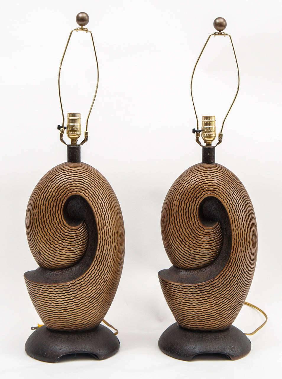 Pair of Artmaster Studios ceramic lamps in shades of gold and black, signed. 21 