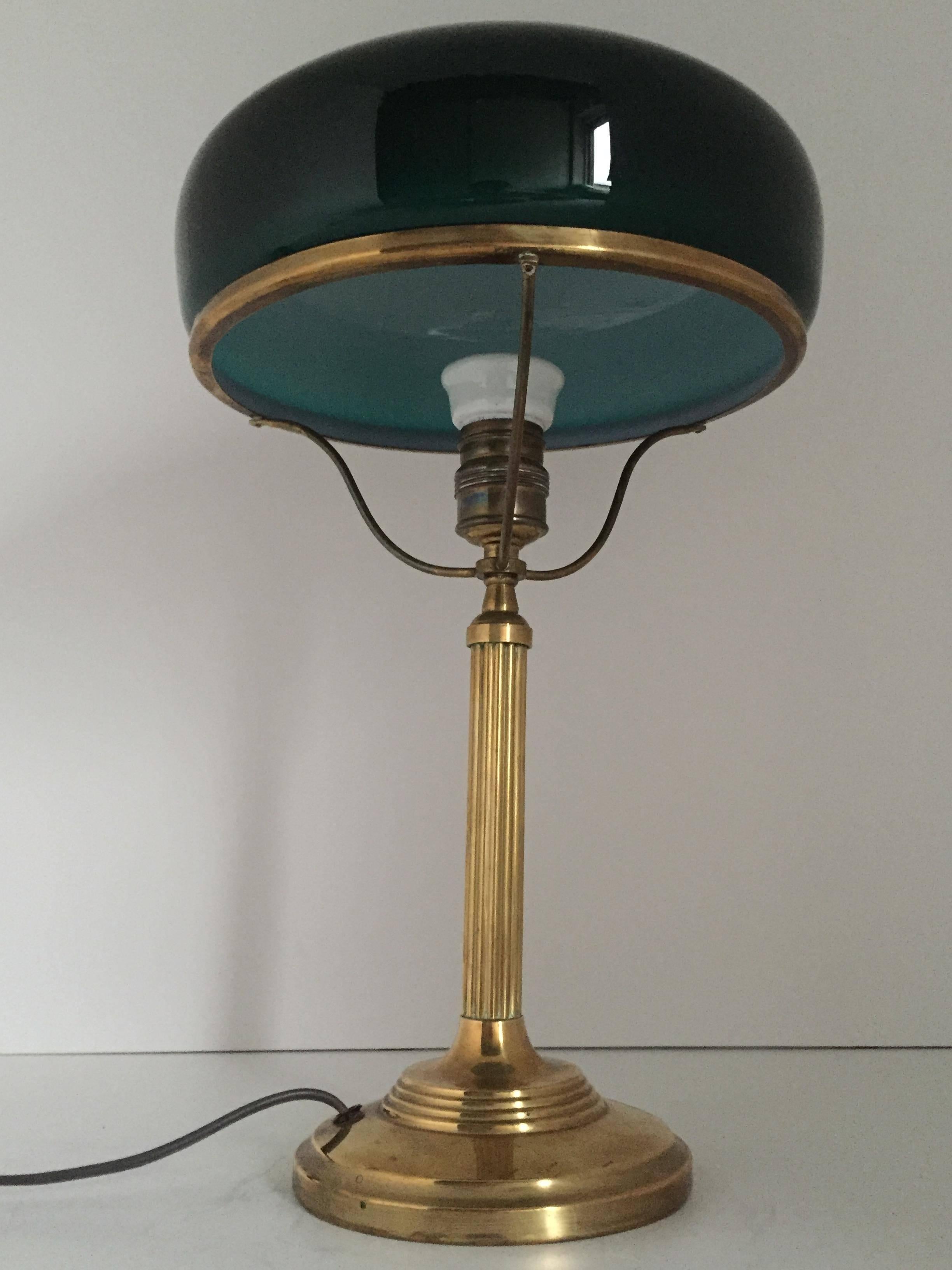 A Swedish 1925 brass table lamp with a dark green glass shade. The old cords has been exchanged to new, but the old switch work very nicely still. Measure: The height is 40cm and the diameter of the shade is 24cm.