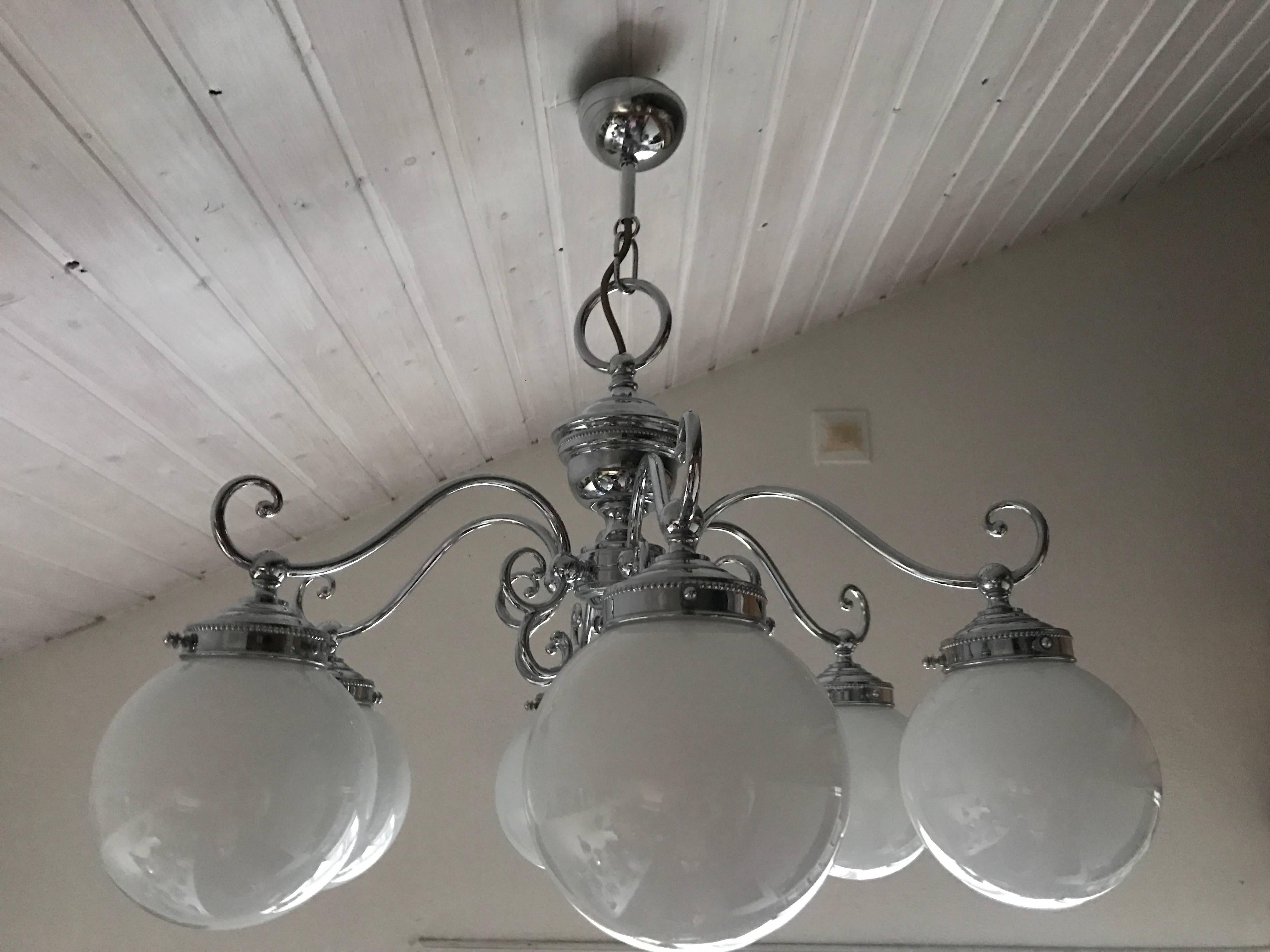 A beautiful and large six-bulb chandelier made of chrome steel and glass. This fabulous chandelier was most likely made in the 1950s in Sweden and it is in the manor of Swedish Grace. The chandelier is in a fantastic condition without any marks,