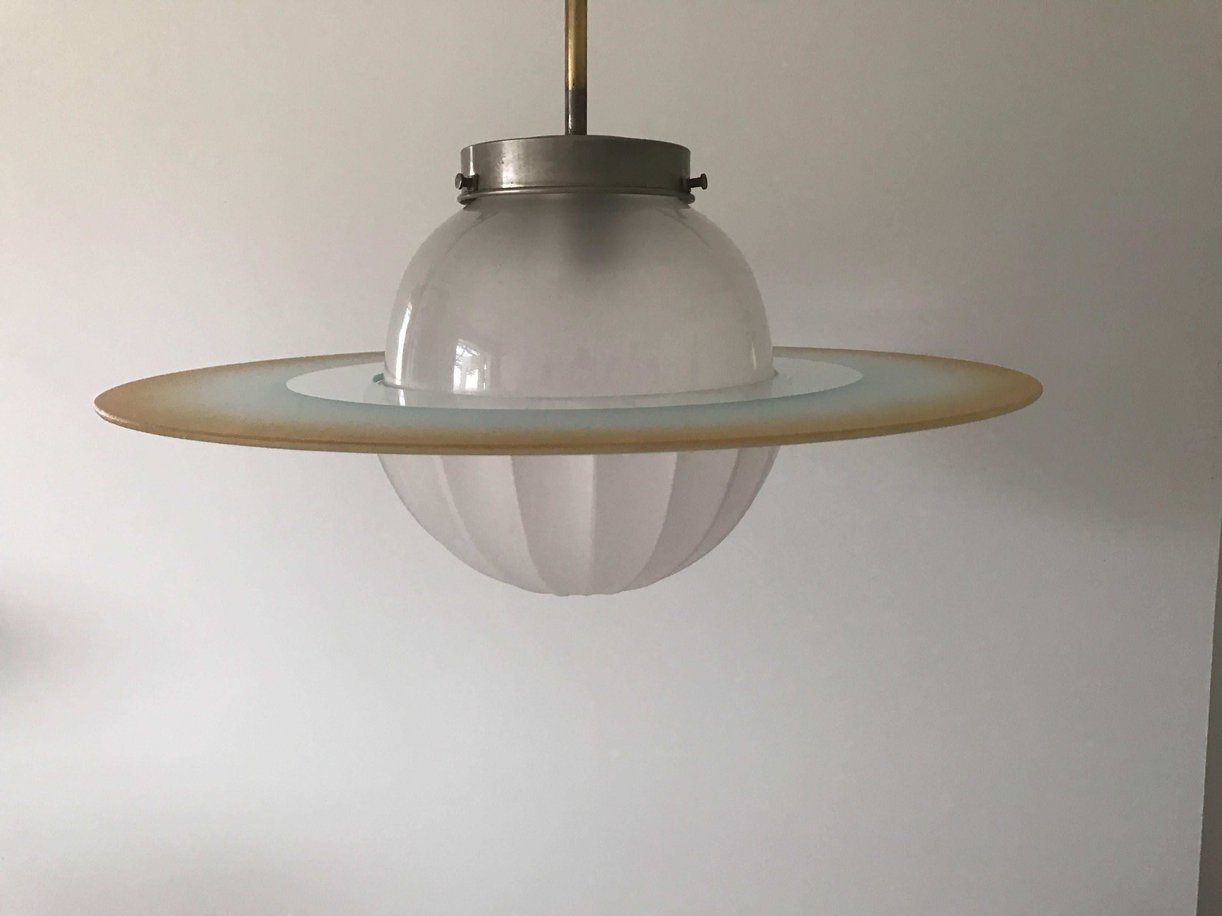 1935 Swedish Art Deco Functionalism glass Saturn lamp.
A very rare and beautiful Saturn lamp with a beautiful skight fading orange disc shade. This lamp was most likely made somewhere around 1935-1940. The lamp is in a fantastic original condition,