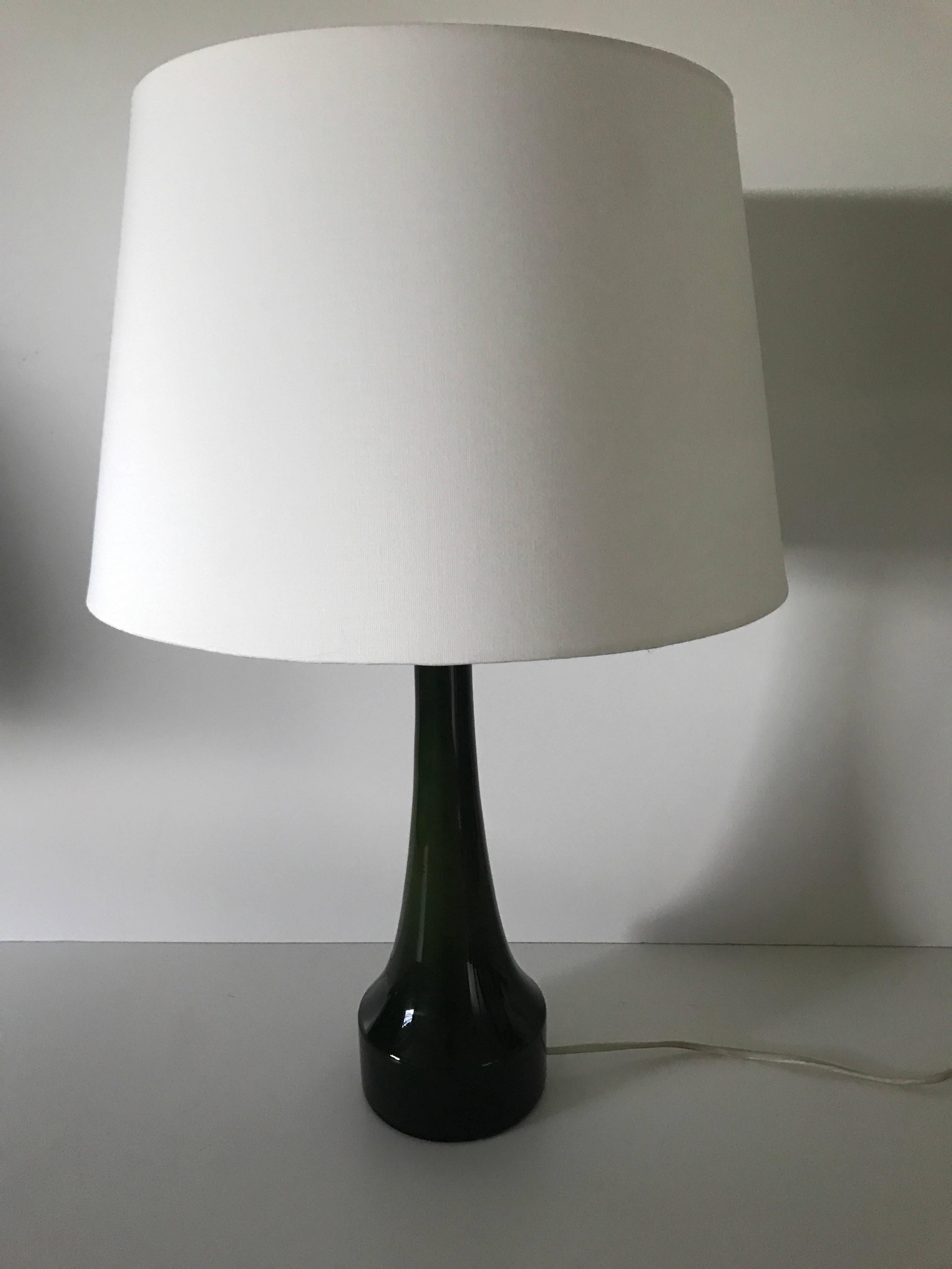 Swedish, 1955 Bergbom and Holmegaard green glass table lamp. A very nice dark green opaline glass table lamp in super condition. The height of the lamp is adjustable and pictured at 53 cm and the diameter of the shade is 34 cm.