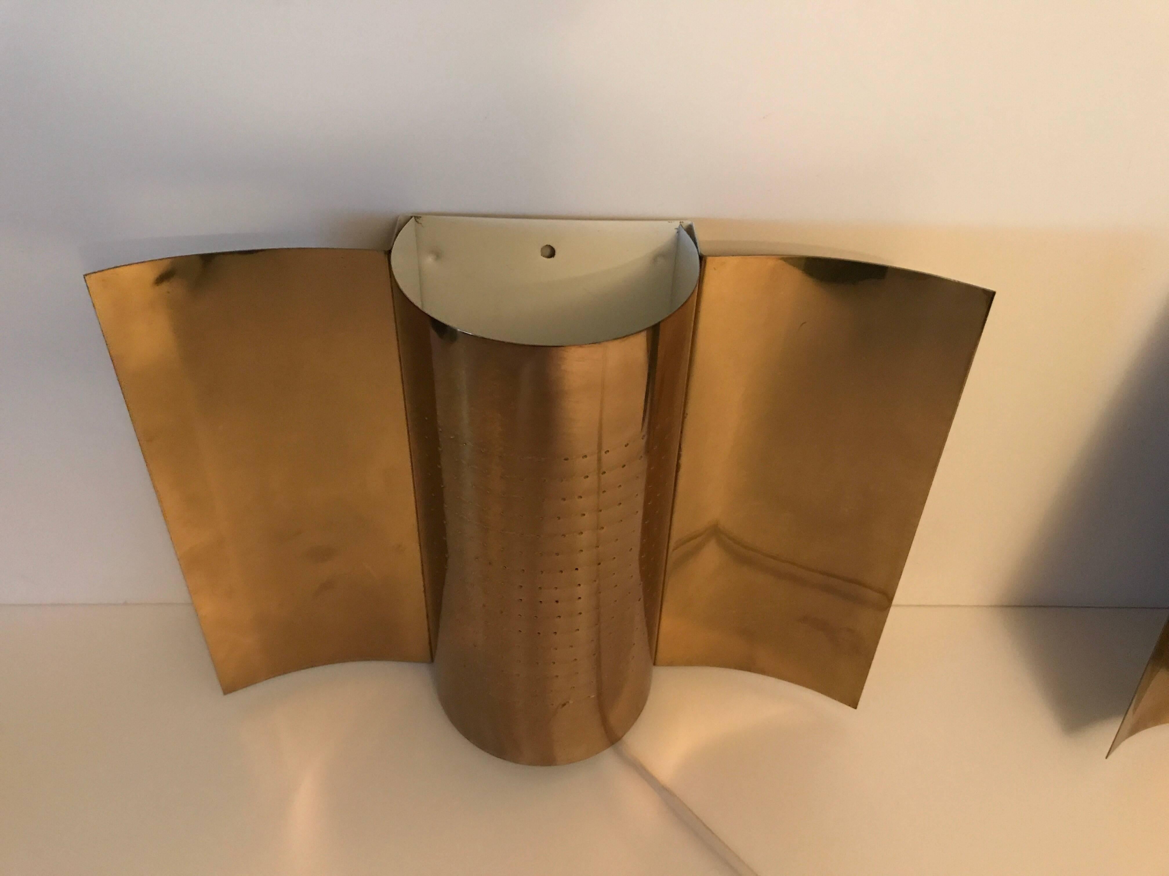Rare pair of Swedish brass wall lamps or wall sconces made by Hemi, circa 1960.
A fabulous pair of perforated brass wall sconces by Hemi Belysning. They measure 33cm in width, 25cm in height and they come out 10.5cm from the wall. The light that