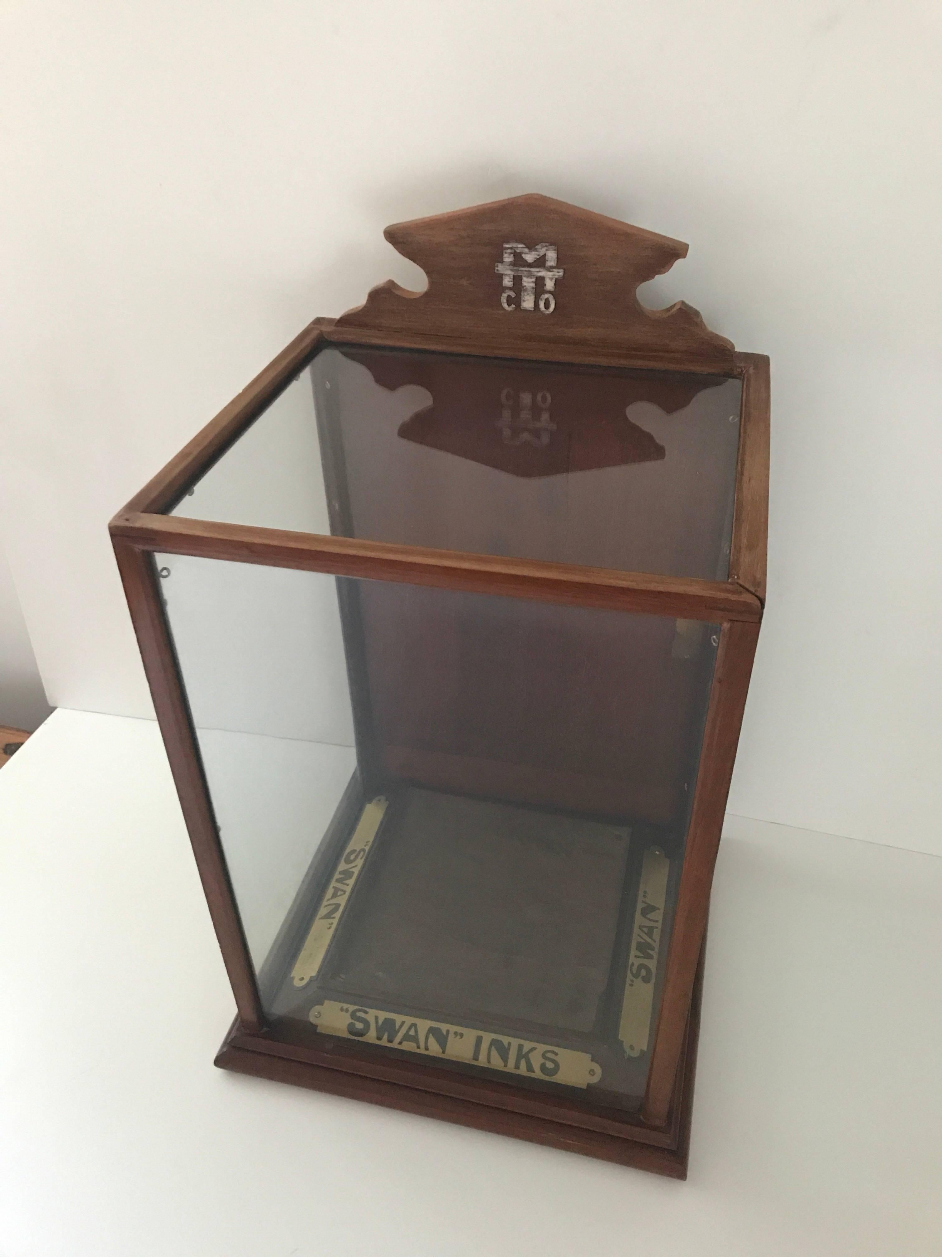 Rare display cabinet or desk display for swan ink early 20th century. A beautiful oak and glass display cabinet made for displaying pens and pencils for swan ink in the early 20th c. The display is missing the key and the knob for the door at the