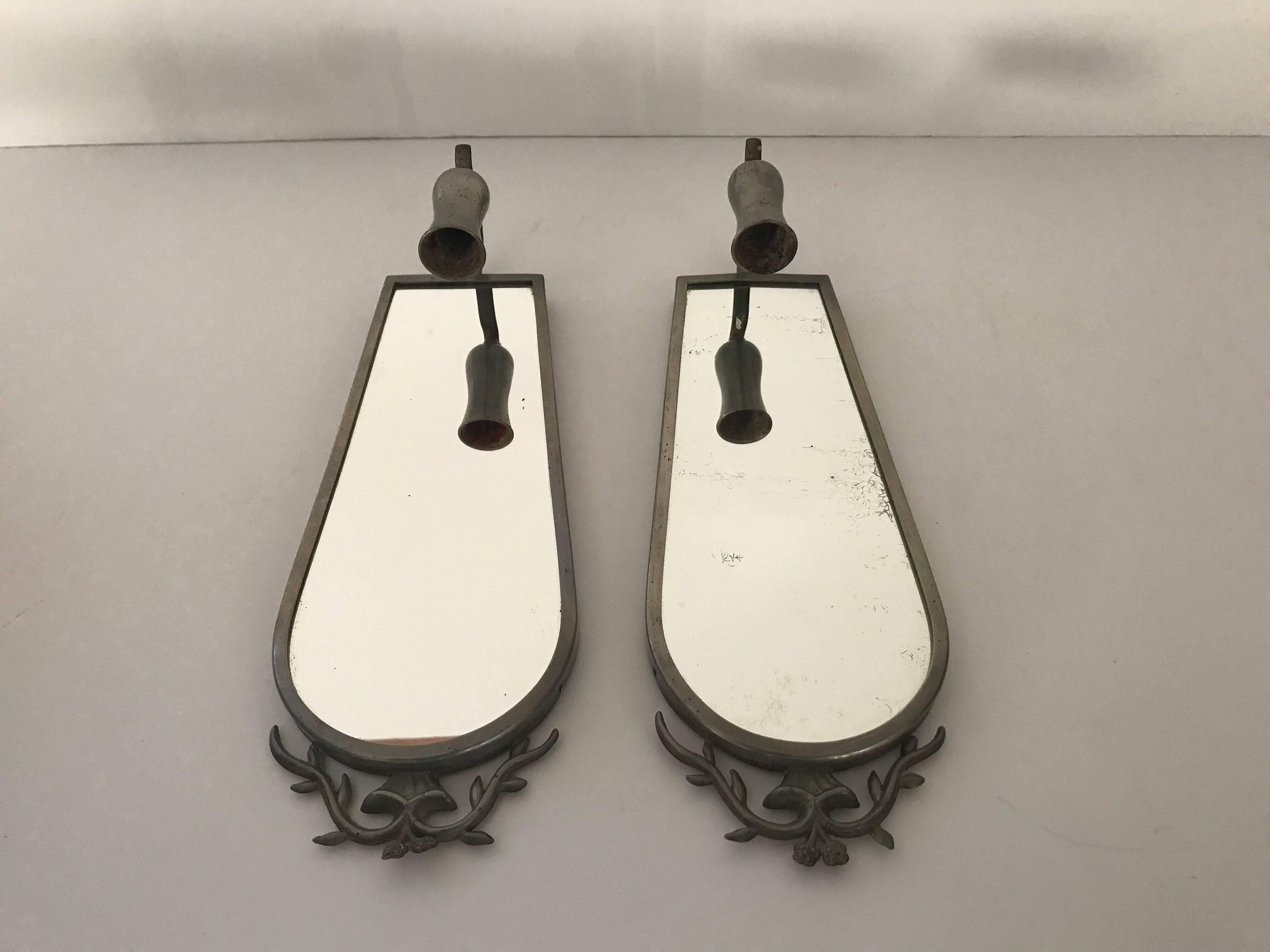 Pair of Swedish Grace pewter mirror candle sconces by Nils Fougsted Svenskt Tenn. A beautiful pair of high quality pewter mirror candle sconces made by Nils Fougstedt and for the high end manufacturer and store, Svenskt Tenn Stockholm. They are in a