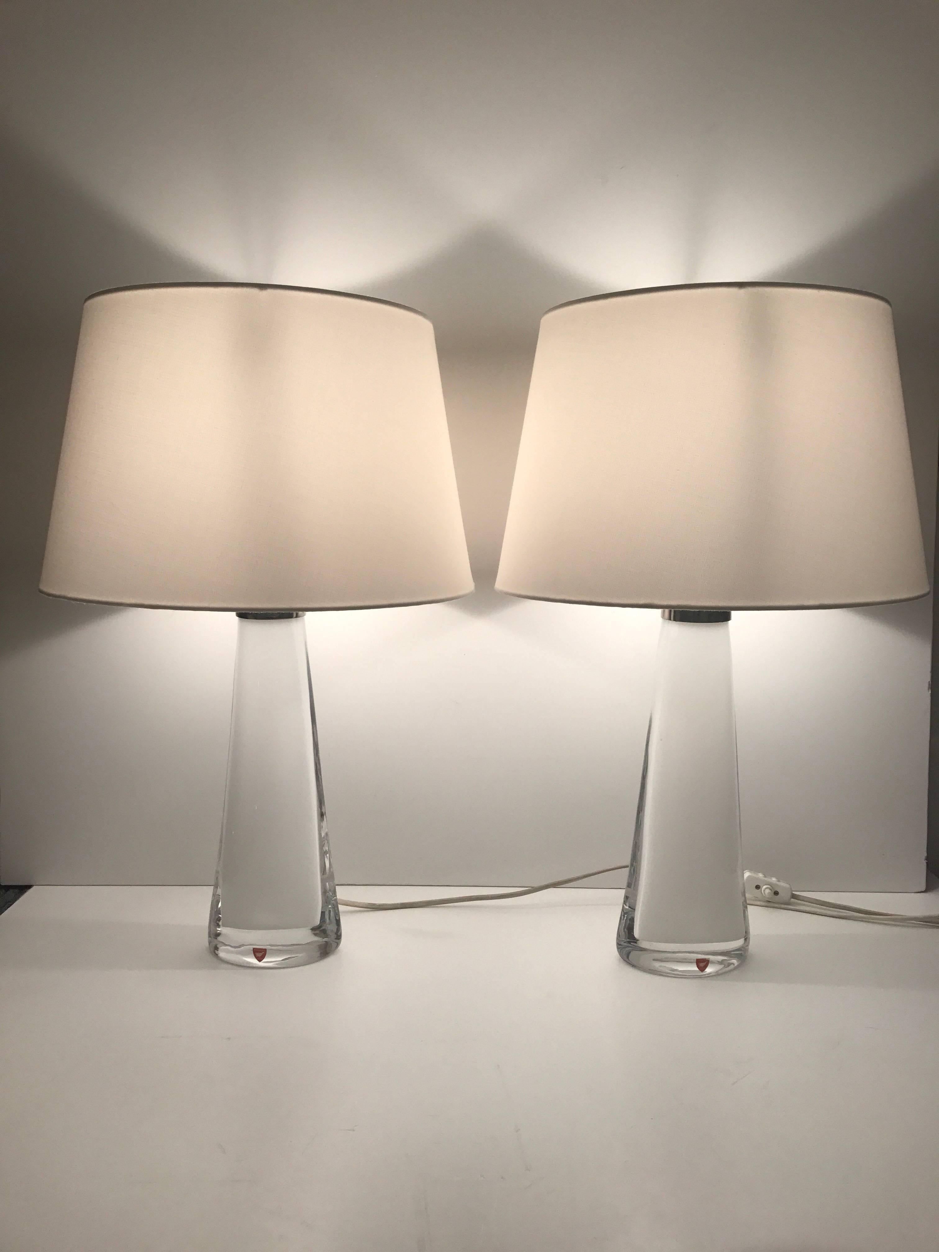 Pair of Swedish Carl Fagerlund white glass table lamps.
A beautiful pair designed by Carl Fagerlund for Orrefors. The lamps are in a fantastic condition without any chips or cracks. The height including the shade is 52 cm and the diameter of the