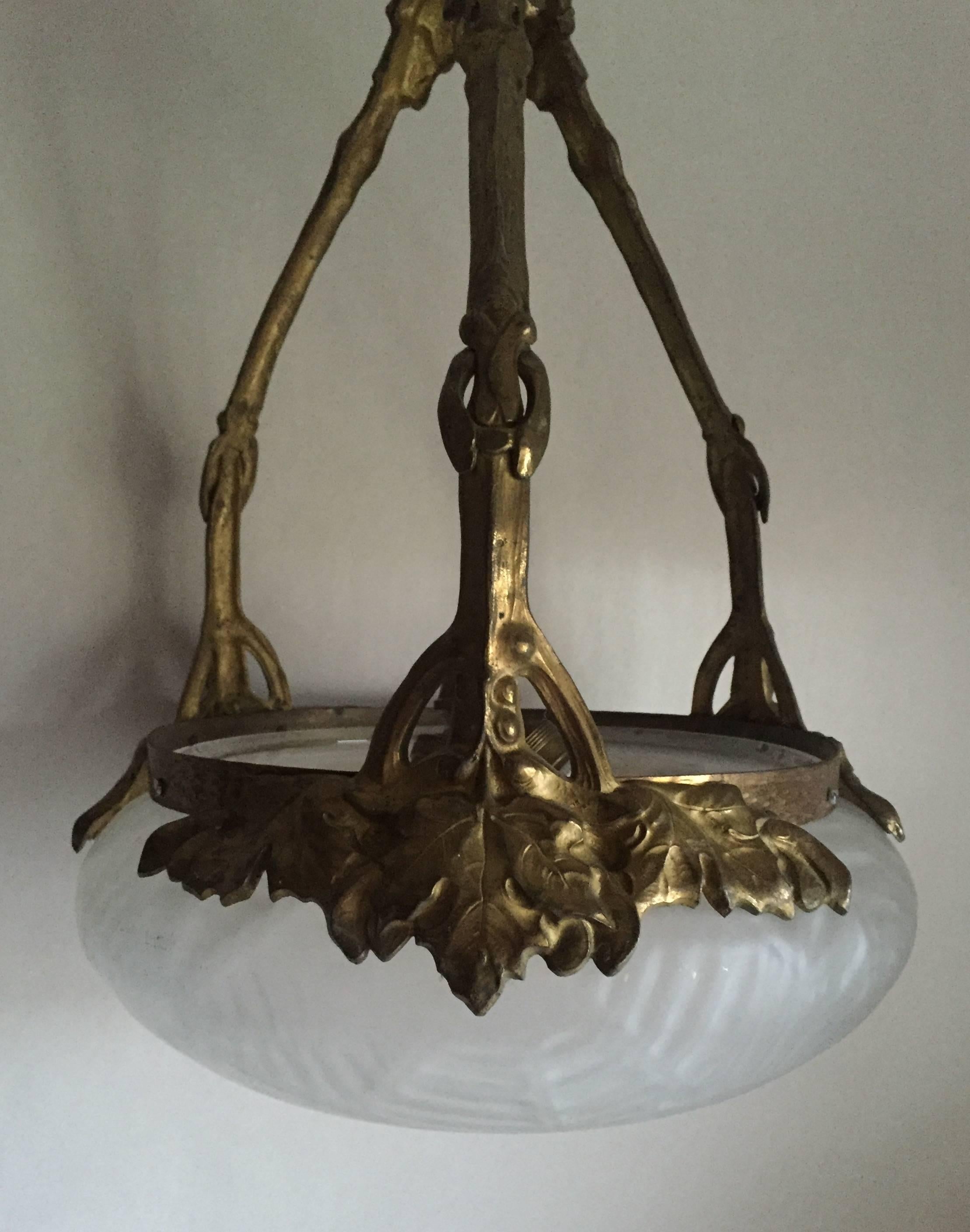 This rare exquisite and beautiful lamp was made by the Stockholm based, long ago closed manufacturer Böhlmarks. It was designed by the Swedish famous sculpture and artist Alice Nordin in around 1910. It is made of gilded bronze and it is in original