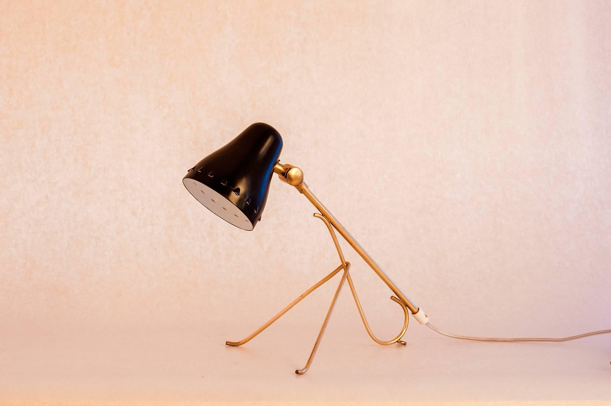 A very nice Swedish brass and steel table lamp made in 1950. It is in a wonderful original condition. The design is very exquisite and has a beautiful light and slim shape.The lamp can either be standing as a table lamp or hung on the wall by the