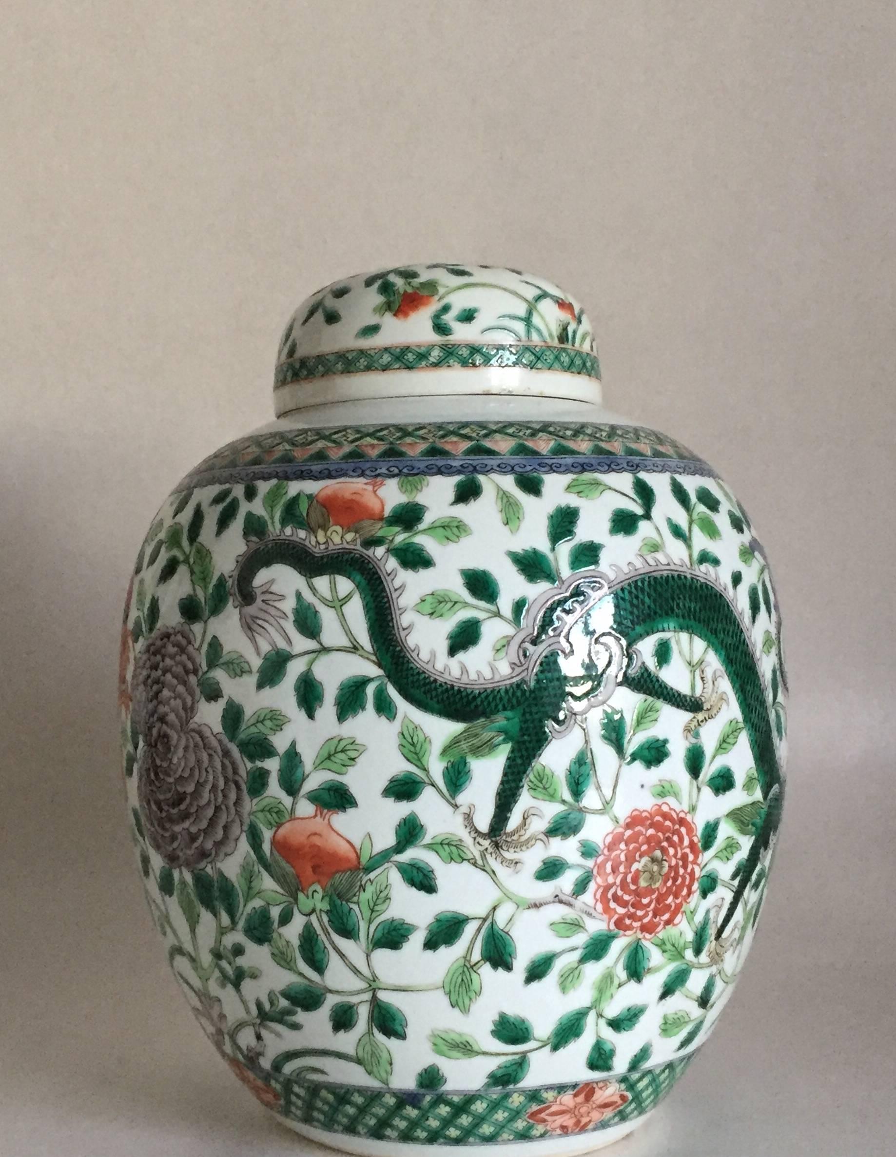 A very nice and large famille verte four claw dragon jar, late 19th-early 20th century, there are two dragons chasing the flaming pearl amongst peonies and chrysanthemum floral sprays and pomegranates. There are two blue concentric rings on the base