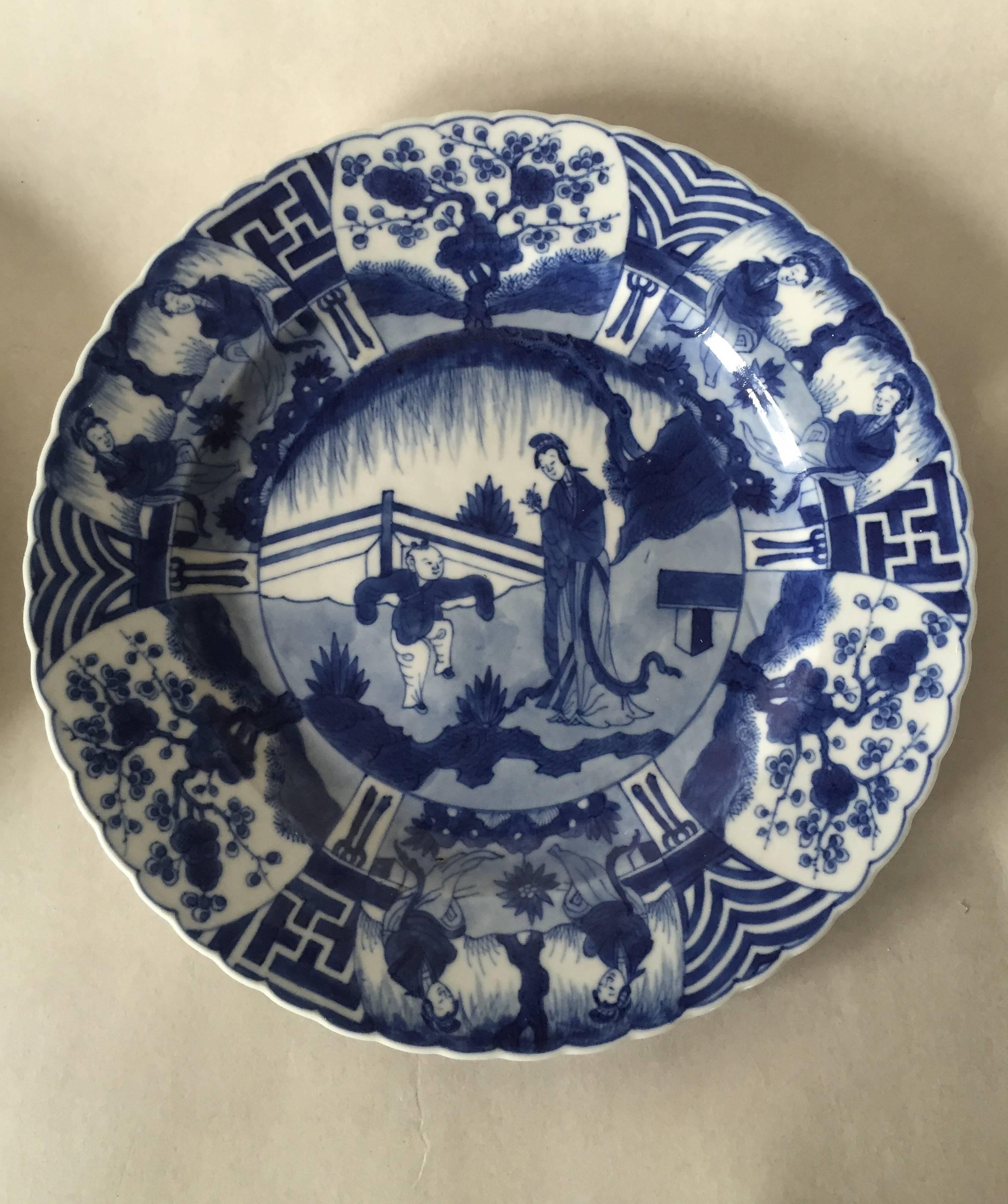 Very rare Kangxi dishes depicting a garden scene with a lady and a child to the reserve. The barbed rim depicts three cartouches with prunus flowers, three cartouches with a swastika three cartouches with waves and three cartouches of two ladies.