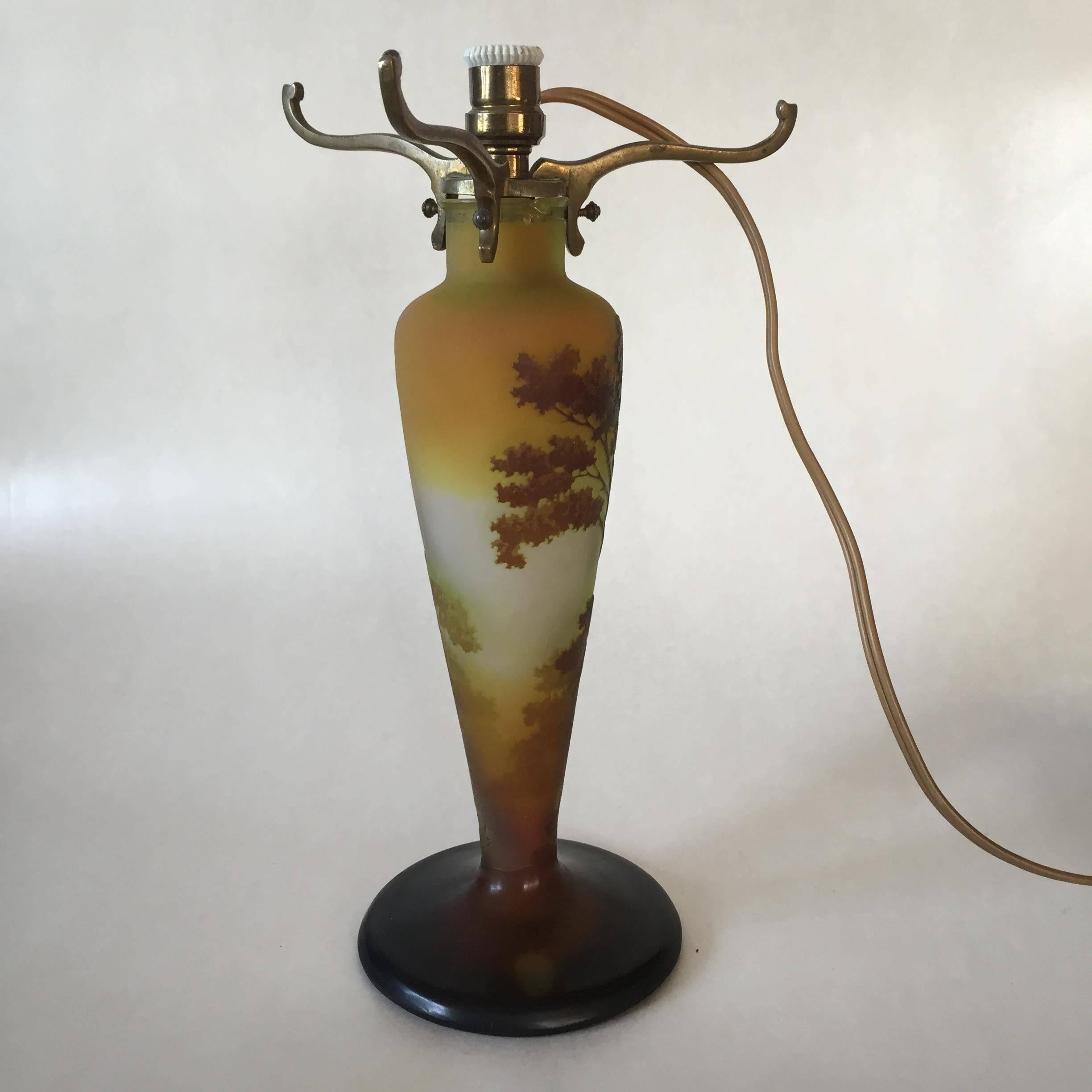 A beautiful Èmile Gallé lamp base, made at the end of 19th century. The shade is unfortunately missing but still this can be a very nice lamp. The glass part measures 24cm and the base is 10.7cm in diameter. There is a tiny chip at the top but not